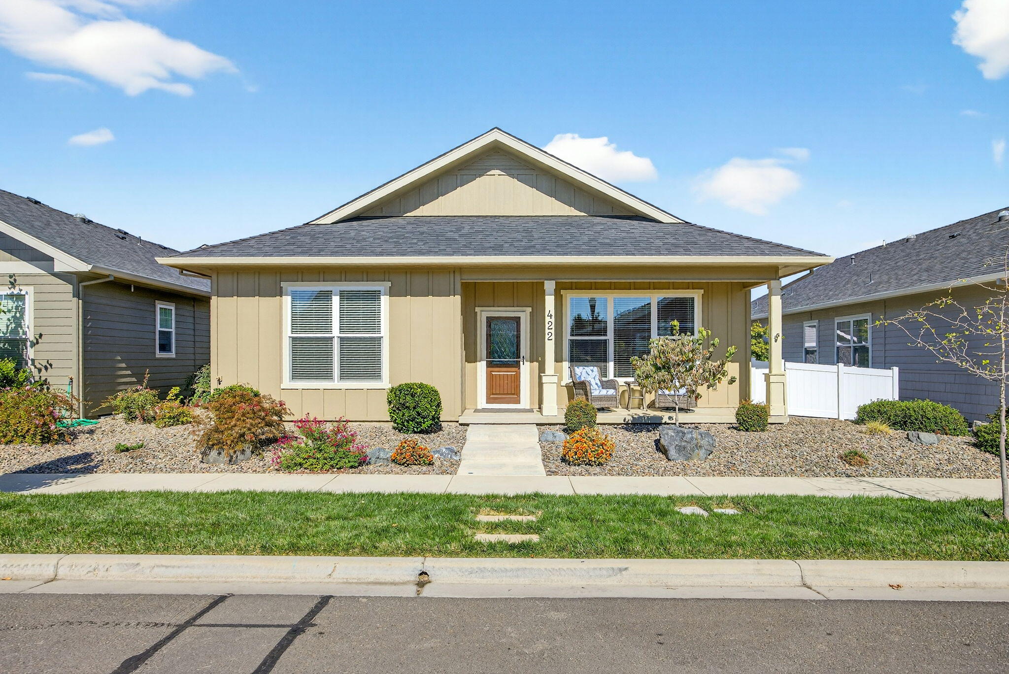 You will LOVE this immaculate, better than new, single level and accessible cottage in the award winning Twin Creeks Development. Just two years old, and shows like a model home. Inviting front porch, EZ care landscaping, large covered patio. Spacious Great Room with gas fireplace, custom shelving, coffered ceiling. LARGE dining area with built in buffet and custom shelving. Kitchen with breakfast bar, granite counters, tile backsplash, and stainless appliances including refrigerator. Built in desk adjacent to large laundry with cabinets and included washer and dryer. Guest bedroom wing with full bath, tall tub and marble surround. Master Bedroom with adjacent bathroom with large walk-in shower, linen cabinet, large walk-in closet. Garage is finished and insulated. Luxury Vinyl Plank in main living areas, tile in baths. Alley loaded Garage is EXTRA wide,  The home is certified Lifelong Housing. Hurry on this one!