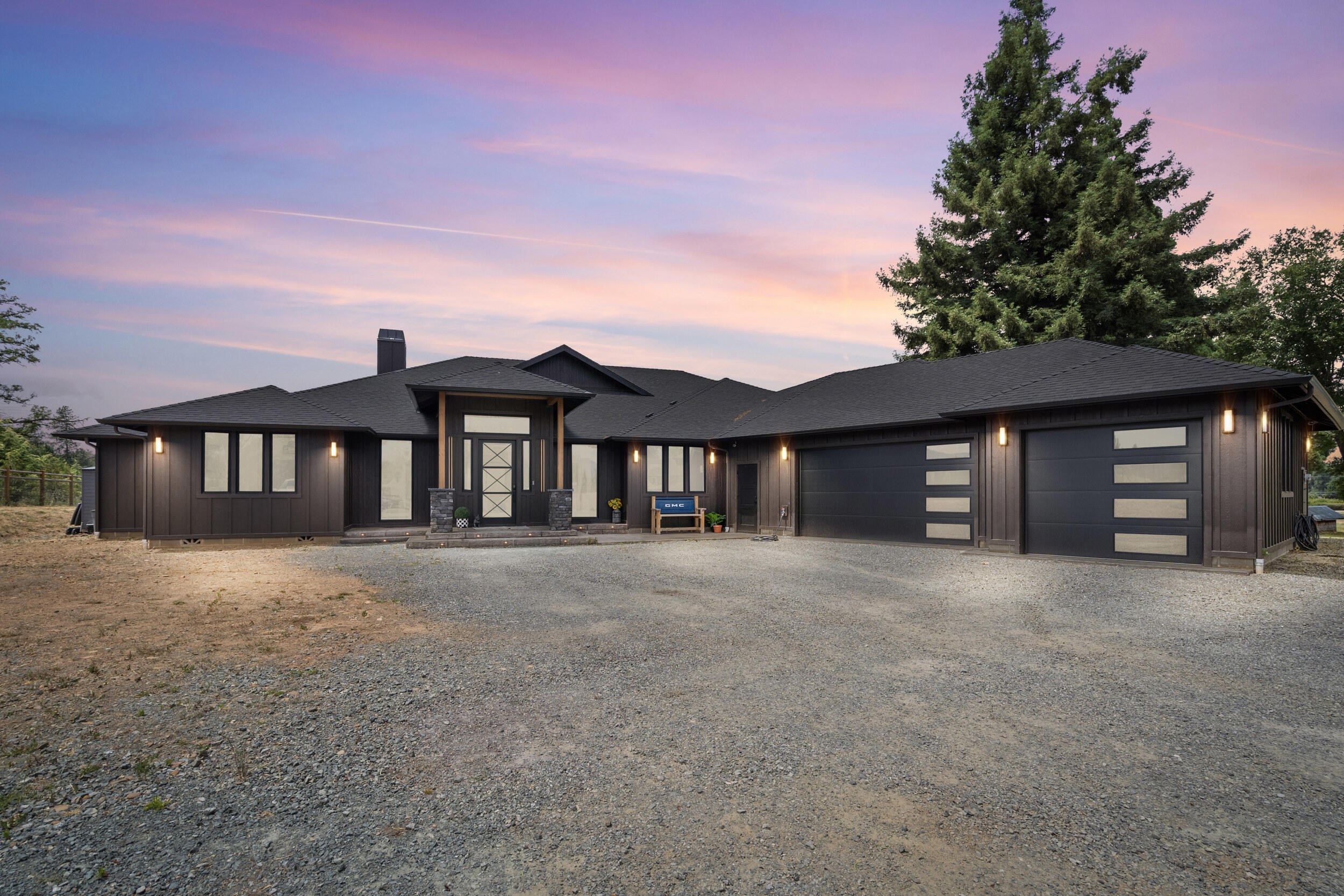 Welcome to 3487 Leonard Rd—a stunning custom-built estate finished in 2024, offering nearly 3,200 sq ft of luxury living on just under 4 usable acres. This thoughtfully designed home features three spacious en suite bedrooms, ideal for multi-generational living or hosting guests in comfort. The grand entry welcomes you with soaring vaulted ceilings and an open floor plan that seamlessly blends elegance and functionality. The gourmet kitchen is a chef's dream with a large island, premium finishes, and ample space for entertaining. Enjoy over 1,500 sq ft of covered patio, perfect for year-round outdoor living and taking in the serene surroundings. A three-car garage provides plenty of storage for vehicles and toys. Don't miss this rare combination of style, space, and modern craftsmanship just minutes from the heart of Grants Pass.