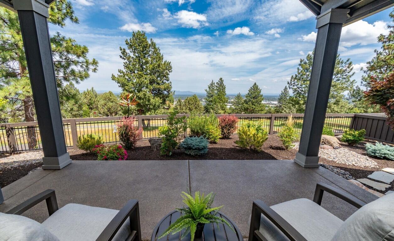 Discover this immaculate single-level gem in NW Bend's desirable River's Edge Village. Offering 3 bedrooms, an office, and 2.5 bathrooms within its generous 2,149 sq. ft. the Wentworth floor plan by Pahlisch Homes offers extensive upgrades and high-end finishes. The light-filled, open-concept living area flows seamlessly, showcasing an enviable kitchen with stainless steel appliances, quartz countertops, and a large pantry. The primary suite features dual vanities, tiled shower, soaking tub, and a walk-in closet with a custom shelving system. Revel in the sunshine from the low maintenance, fully fenced yard with massive golf course frontage and expansive easterly views. The covered patio is ideal for year-round enjoyment. Additional features include an Aprilaire humidifier, an Air Scrubber Pro air purification system, custom window coverings, and abundant storage. Conveniently located near trails, shopping, dining, and the Old Mill, this is your basecamp for Central Oregon adventure!