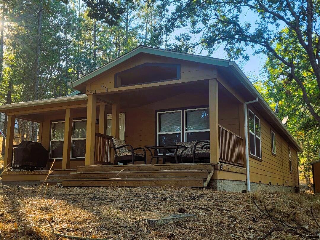 Pine Hollow Gem nestled on private wooded half acre lot with Lake View. Warm & inviting home immaculately maintained. 3Bd/2bth 1500+ SF. Vaulted ceilings, Knotty Pine doors, cabinets & trim. Kitchen Island & Pantry. Dining room. Mudroom. Spacious Master Suite. Windows look out on woods everywhere. Covered porch. Dead End location 1 block from Lake Access. Updated carpet w/ memory foam pad. Dual sinks in Master Bath. Heat Pump. Longitudinal steel support. Oak Mantel Wood Burning FP. Popular Air BnB Rental option, or quiet secluded full time or getaway home. Motivated Seller! Life is better at the lake. Move in ready!