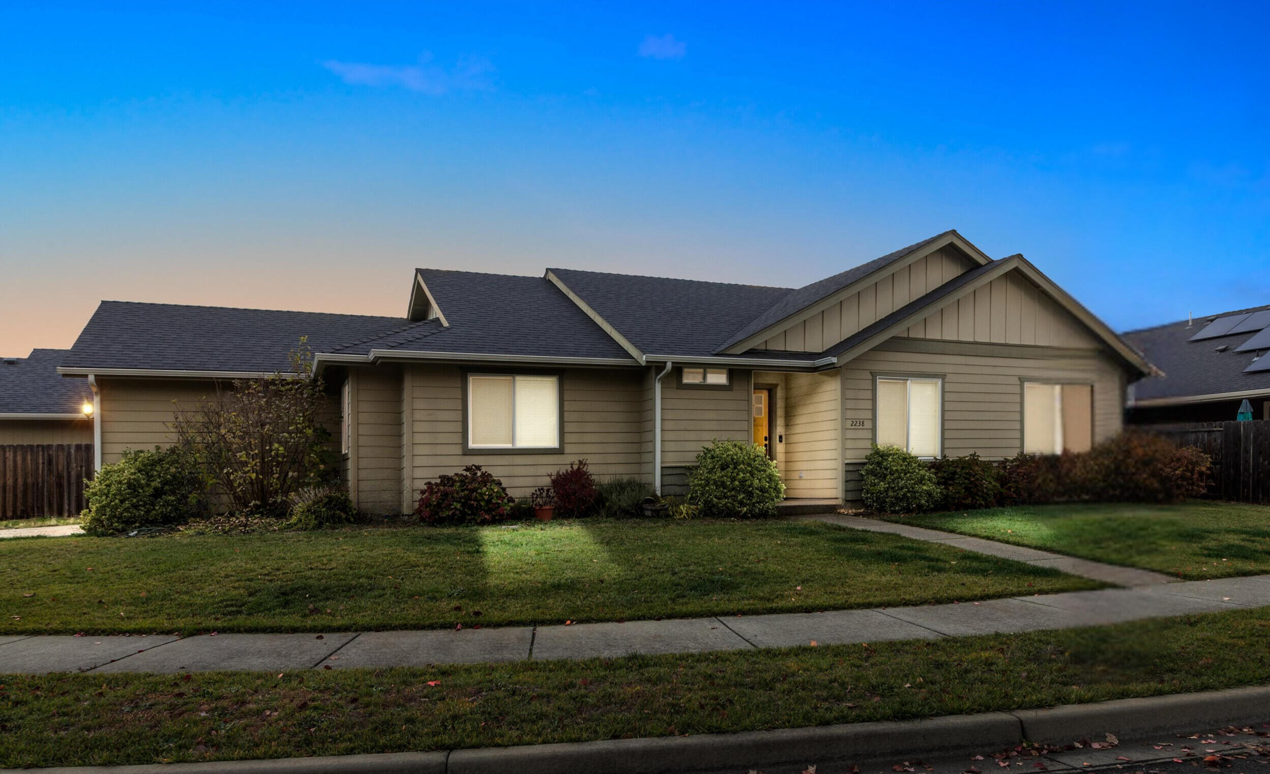Welcome to 2238 SW Gayle Way, a stunning property located in the heart of Grants Pass! This beautifully maintained home features a light-filled, open floor plan with soaring vaulted ceilings that create a warm and inviting atmosphere. The spacious kitchen offers ample counter space and modern finishes, perfect for preparing meals and entertaining guests. The primary suite is complete with a walk-in closet and an en-suite bathroom. Step outside to enjoy the covered patio and a fully fenced yard, ideal for relaxing or hosting gatherings. This home is conveniently located near schools, parks, and local amenities, making it perfect for anyone seeking both comfort and convenience.