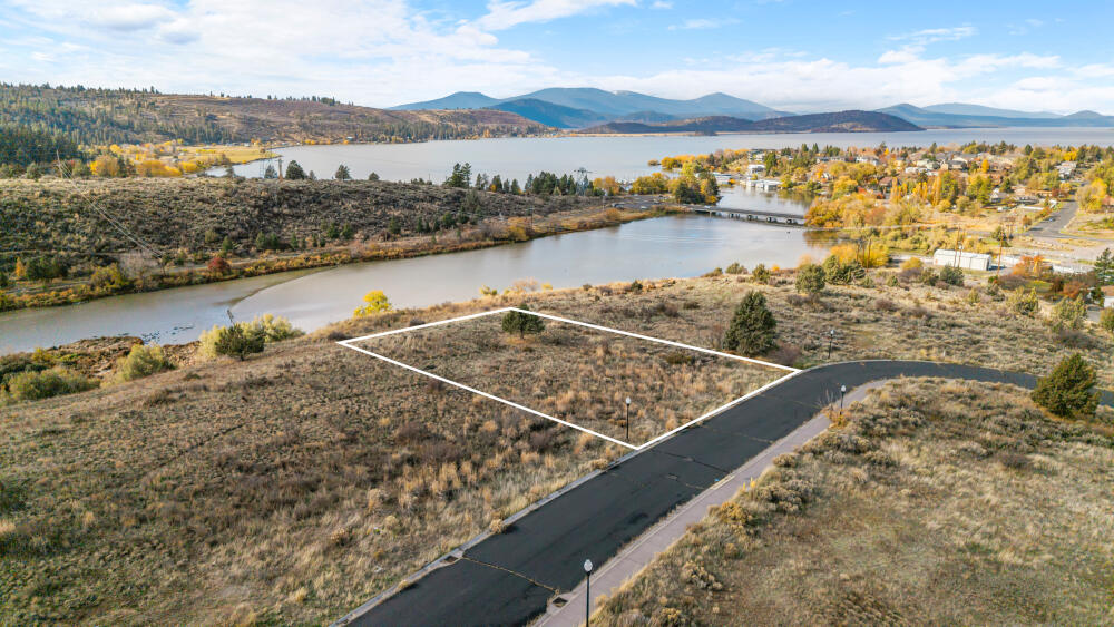 Incredible view lot overlooking Klamath Lake! Discover the perfect place to build your dream home on this mostly level lot offering stunning views of both Link River and Klamath Lake. Situated on a paved loop road within an undeveloped subdivision, this property combines peaceful surroundings with the convenience of city amenities. City water, sewer, and power are all available at the street—making your building plans easier than ever. Enjoy nearby access to Moore Park's scenic trails, boat launches, and the conveniences of Sky Lakes Medical Center and OIT just minutes away. A rare opportunity to create your own piece of paradise in Klamath Falls!
