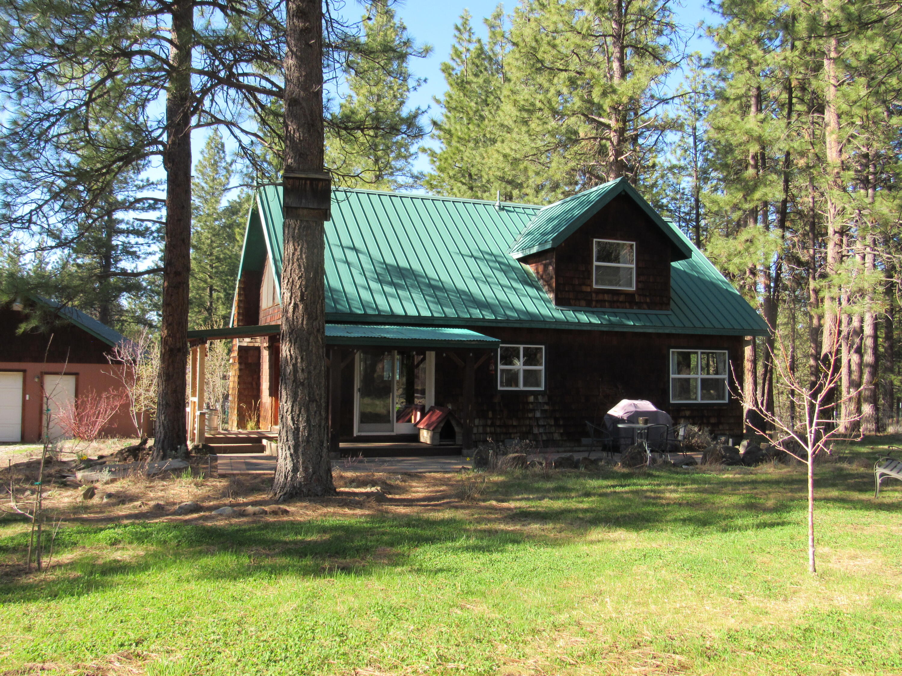 Great home  with large ponderosa pines. Home is 2 bedroom 1 bath, with master bedroom on main level.  Also a loft bedroom. A nice open kitchen with plenty of cabinets. Ponderosa Pines dot the 2.5 acres all fenced with room for a horse.  Chicken house you can grow your own eggs. Large fenced garden with a green house, 6 fruit trees, raspberry patch and a mature asparagus patch.   Outside a nice patio . Detached 1 car garage with work shop area.  An R.V. garage, and a wood storage. Close to a small community.  Call today for a showing.
