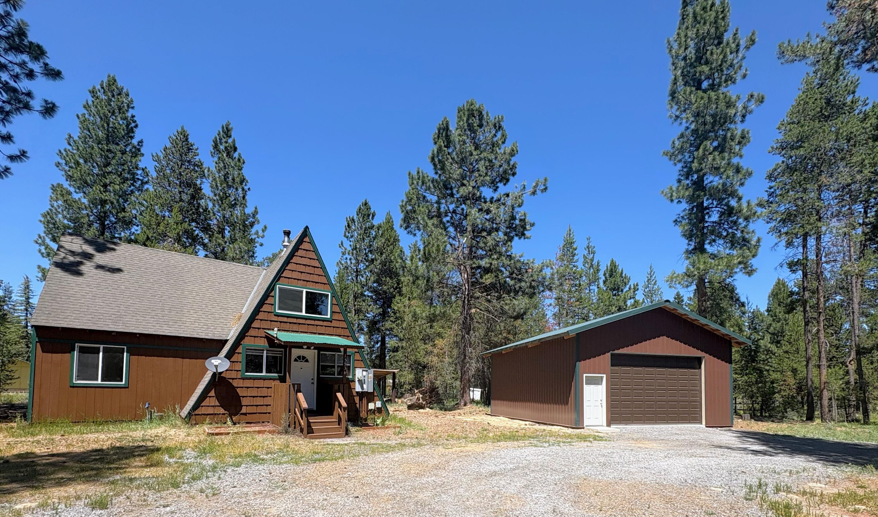 Welcome to this cozy A-frame home, set on a clean and level acre of land. The exterior has been freshly painted, and a brand-new 26x30 pole barn has just been built, perfect for storing your outdoor toys and vehicles. Inside, you'll find an efficient wood stove and a spacious open kitchen. The downstairs area features two bedrooms, while the upstairs includes a large bedroom and a bonus room that can serve as an office or a fourth bedroom if needed. The property also includes a convenient circular driveway. Located in La Pine, where you can enjoy all four seasons, including activities such as skiing, snowboarding, snowmobiling, fishing, boating, hiking. and ATVing.