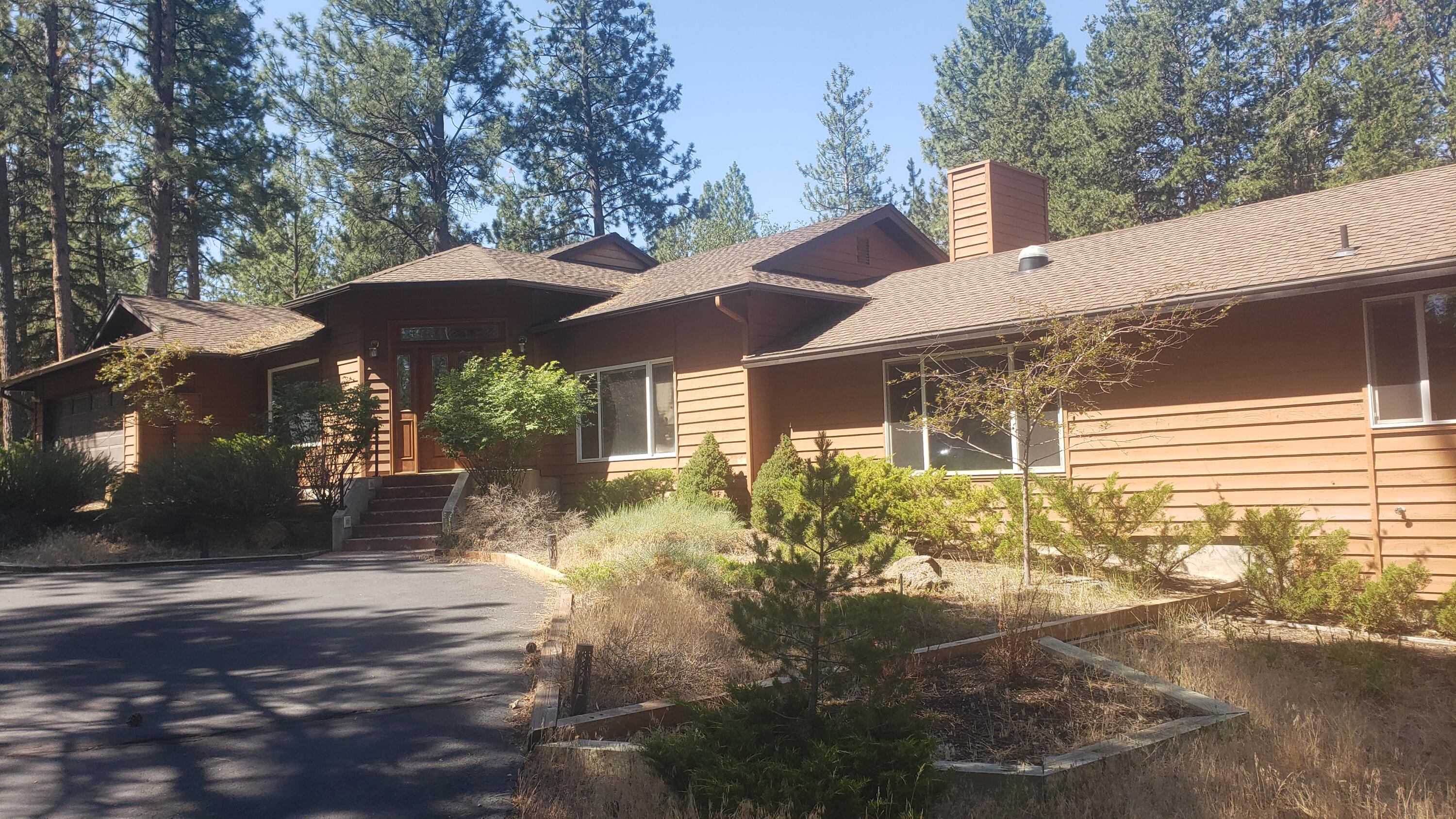 Coveted Woodside Ranch residence with all the important features and Priced to sell. Detached second garage/shop  w/apartment, as well as another shop building which can be used for so many different things. Large coop with adjacent big screened area to keep animals safe/contained. Over 2 and 1/2 acres of level ground to call your own, and have plenty of privacy. The main home also has a second kitchen and living space for those wishing to have loved ones live within but private, and/or any other needs you may have, Brand new HVAC system completely zoned throughout and has a medical grade filtration system.