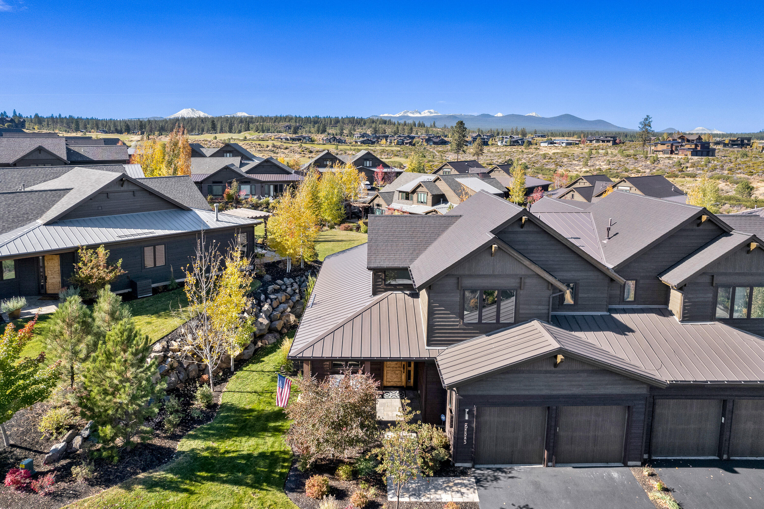 Elegance meets sophistication in this stunning Triple Knot townhome. A coveted location overlooking lush greenspace and not one, but two idyllic ponds along with Cascade views. Appointed with all the amenities you'd expect including modern cabinetry and stunning hardwood floors. On the main level you'll find a primary suite, office, laundry, and great room with a handsome floor to ceiling fireplace offset by generous windows and warm wood beam accents. There are two additional suites upstairs, the south suite offers awesome Cascade views while the east captures the first morning light. The primary patio is adjacent to a lovely pond in full display of fall colors. This is truly an exquisite home in an exceptional location.