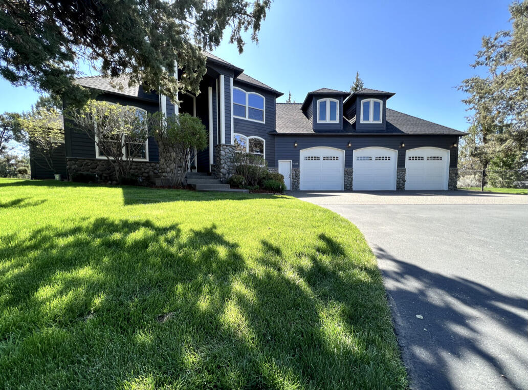 Highly sought after Old Deschutes neighborhood - 2.5 acres - historic Pilot Butte canal frontage. Majestic river rock fireplace invites you in.  A chef's kitchen opens to a spacious living area that leads to  the expansive deck, perfect for hosting large gatherings. Sit around the fire pit as you enjoy the tranquility of the flow of the river canal.  Main floor primary ensuite bedroom boasts a rock fireplace - French doors open to deck.  Beautiful wood pillars accent the great room and lead up a grand staircase to the 2nd floor landing with open balcony and 3 bedrooms, 2 bathrooms, + large theater/bonus room-outside deck access. Attached oversized 3+ car garage and detached 3040 sq ft shop-2 RV bays, offer plenty of storage space-ADU potential. Fenced dog run/garden area. Underground irrigation, smart technology operated.  Rock wall-lined pond & gorgeous cascading waterfall feature w/ gazebo & sitting area, perfect spots to relax and soak in the serene pastoral surroundings