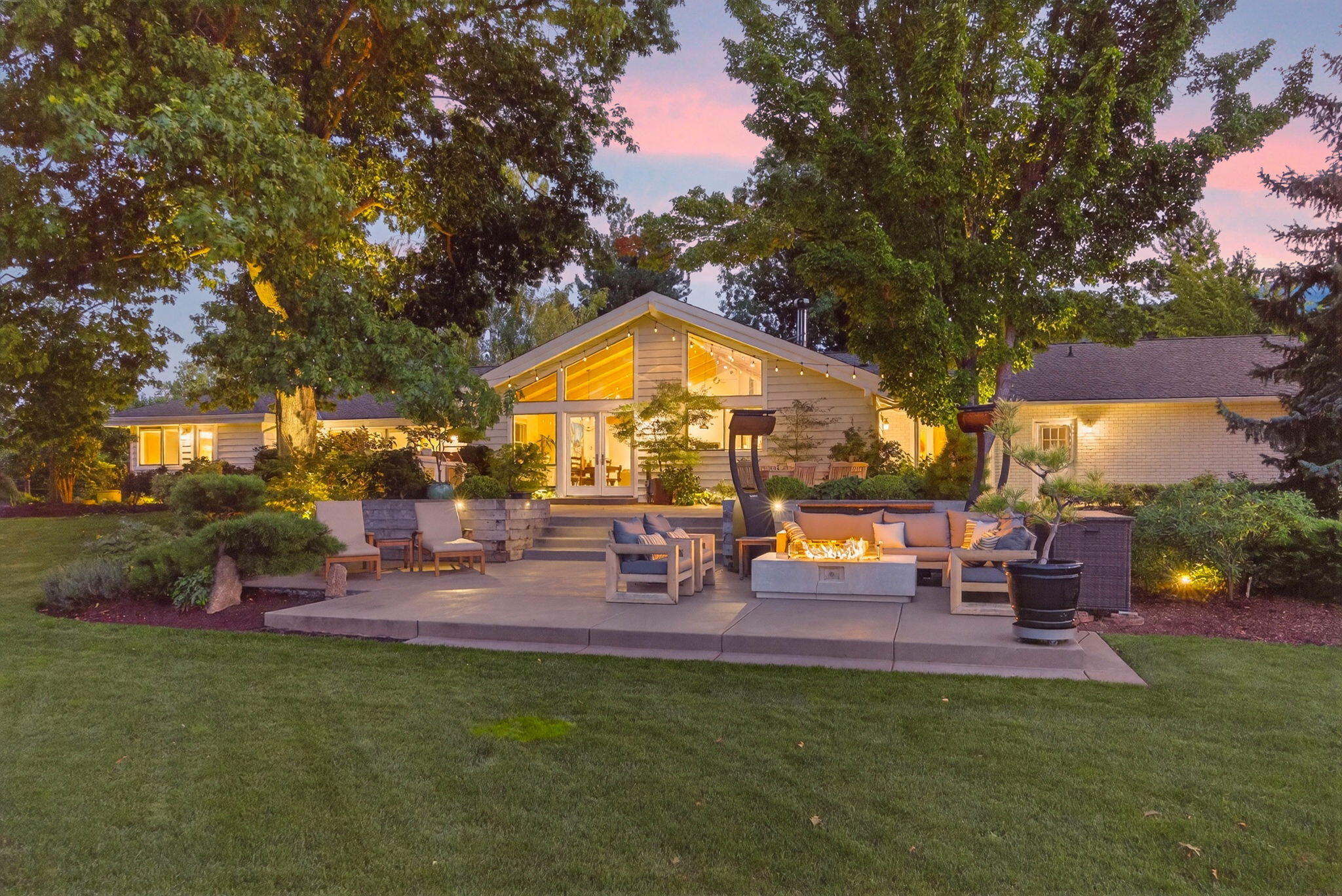 The pinnacle of country living on 7 acres just minutes from town. This ranch-style home blends modern updates w/ country charm + irrigation rights from TID & Neil Creek. Wood-lined vaulted ceilings, birch floors, & large windows frame pond & pasture views. Open concept kitchen w/ Quartzite counters, Wolf appliances, pot filler + island. Great Rm invites cozy gatherings by the woodstove. Designated office + secondary living area w/fireplace. Primary suite w/ granite, tile shower, & corner tub + direct access to the hot tub & patio. Two guest rooms share a hall bath + addtn'l en-suite guest quarters. Professionally designed Japanese garden theme will please the most discriminating buyer. Extensive entertainment areas include outdoor kitchen & specialized lighting illuminates the patios, pathways & exquisite plantings. Cross fenced pastures, orchard, pond, greenhouse, raised beds, & barn w/ separate access; perfect for toys/hobbies/animals. This property offers beauty, function, & space.