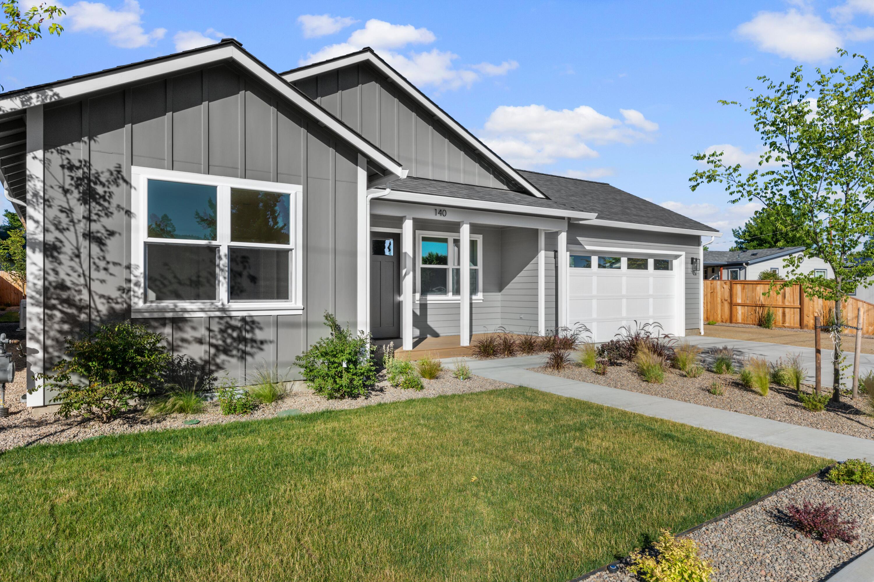 Live the lifestyle you want with a custom new energy efficient home that is perfect for entertaining! This 1,610 sf 3/2 single level home sits just a block from downtown Talent on a .16 acre lot. Step inside and you'll notice the beautiful stylish finishes, tile in the bathrooms, and new stainless appliances. The great room is light and bright with spacious windows, wood flooring, custom fireplace hearth with shelving, large island with eating bar, and extensive stone counters throughout. From the street, you'll notice an inviting covered front porch, Fire-wise landscaping with sprinkler and drip irrigation, RV parking, and an attached two car garage. From the house everything that Talent has to offer is easily accessible. Call for an appointment before the home is sold!
