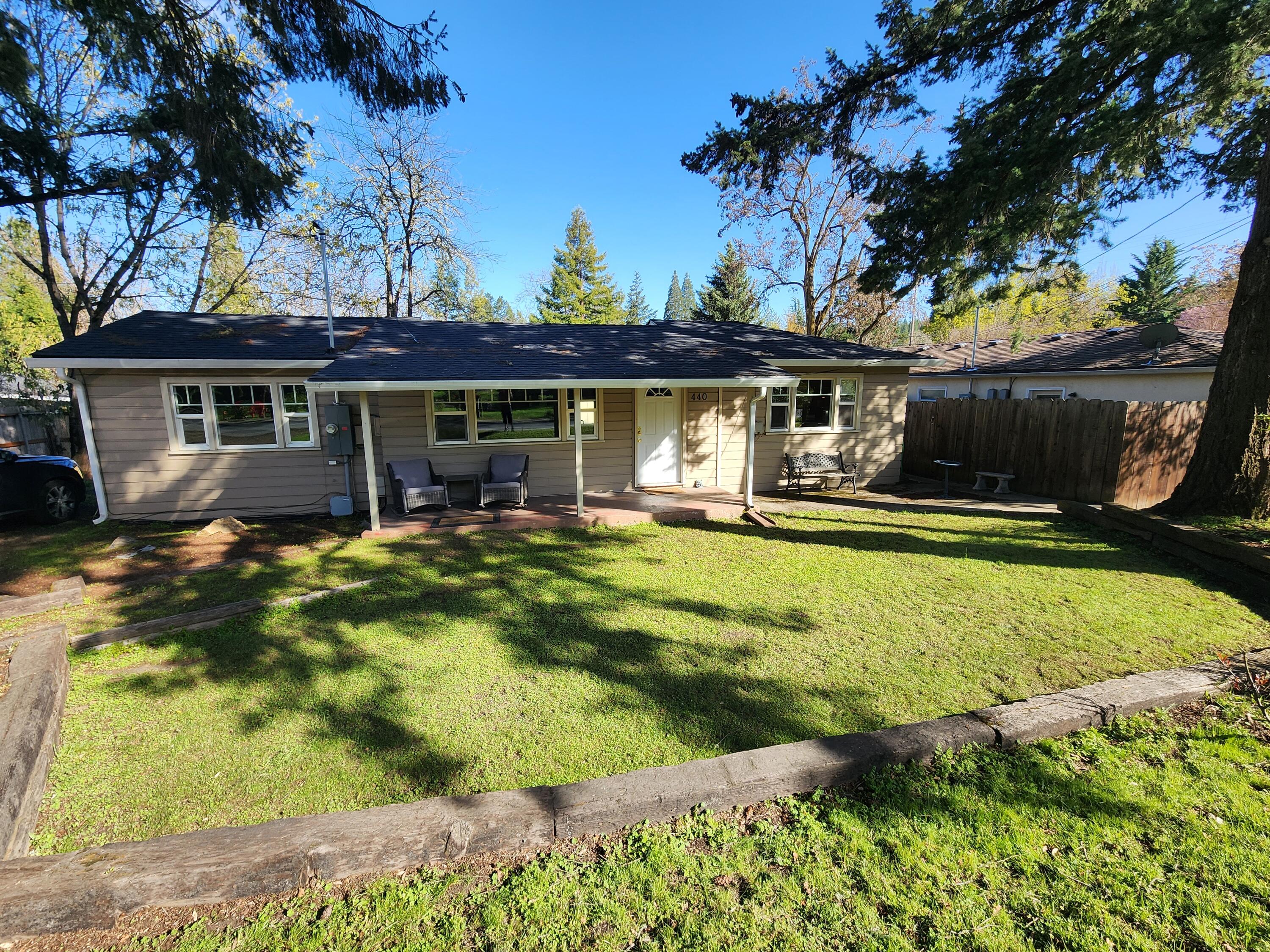 Rare Investment Opportunity in the Heart of Jacksonville! This unique corner-lot property features a charming single-family home plus a duplex, offering endless possibilities for investors or owner-occupants looking to offset their mortgage with rental income. Located in a highly walkable area near shops, restaurants, wineries, hiking trails, Ray's Food Place, the Britt Festival, & more - this is small-town living at its best. The 2 bed / 1 bath main home boasts a spacious kitchen, open living area, mud/laundry room, welcoming front porch, and large yard. Each 1 bed / 1 bath duplex unit includes an open great room, kitchen with breakfast bar, walk-in closet, tile shower, & stackable washer/dryer. One unit even has a fenced backyard w/ turf & patio. Off-street parking is available for all units. Currently operating as furnished mid-term rentals, this property is turnkey! Live in one & rent the others or rent them all (mid- or long-term rental options).  So many possibilities!