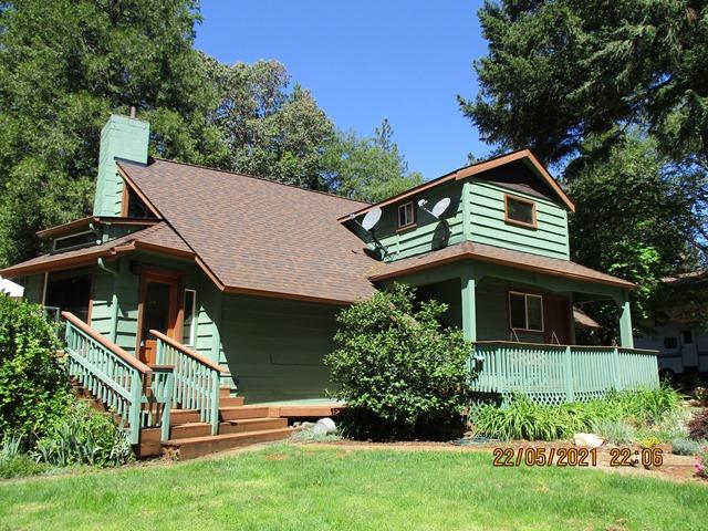 Need room to spread out? This 2.17 level acres located just minutes to town has many possibilities. Nicely updated home with wrap around deck, 3 year old roof and exterior paint features 3 bedrooms, 2 baths, 1916 sf, vaulted ceilings with picturesque windows, certified wood stove, kitchen with island and tile flooring, dining area, hand scraped hickory hardwood floors throughout, laundry room, loft area and office space.  2 barns currently used for storage, 15'x 14'work shop, art studio or playhouse, 27' x 36' RV or boat covered parking, chicken coops, koi pond, 22' x 23' 2 car detached garage and wrap around deck are a few of the outside features. Towering pines, apple, peach and plum trees along with beautiful flowering shrubs surround the grounds. Completely fenced and gated.  Property includes 2 way access, from Sugar Pine or Verde.  Plenty of room for an additional dwelling and would make a fantastic horse property.