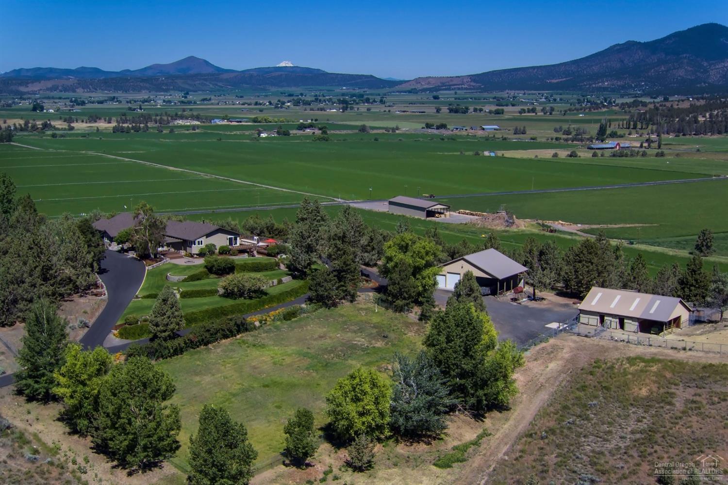 McKay Road Ranch is a country estate on 106 acres with stunning Cascade Mountain, Crooked River Valley and McKay Creek Canyon Views. The property includes 3 taxlots; approved for two legal dwellings; 43 acres of irrigation water rights with wheel lines; 3 Wells; Shop 1296 sf insulated/heated; 5760 sf Hay shed; Livestock barn is 36x36 with stalls, kennel, tack room; outdoor arena; greenhouse; gated entry and paved driveway. Custom Home was completely remodeled in 1990's: 4456sf, 3 bedrooms, 2.5 bathrooms, country kitchen, breakfast nook, pantry, commercial size cooler, utility room, quality finishes throughout. The outdoor living includes decks, patio, swimming pool, beautiful landscaped yard, gardens and fruit trees. Wonderful opportunity for a private hilltop estate acreage just 5 minutes from town.
