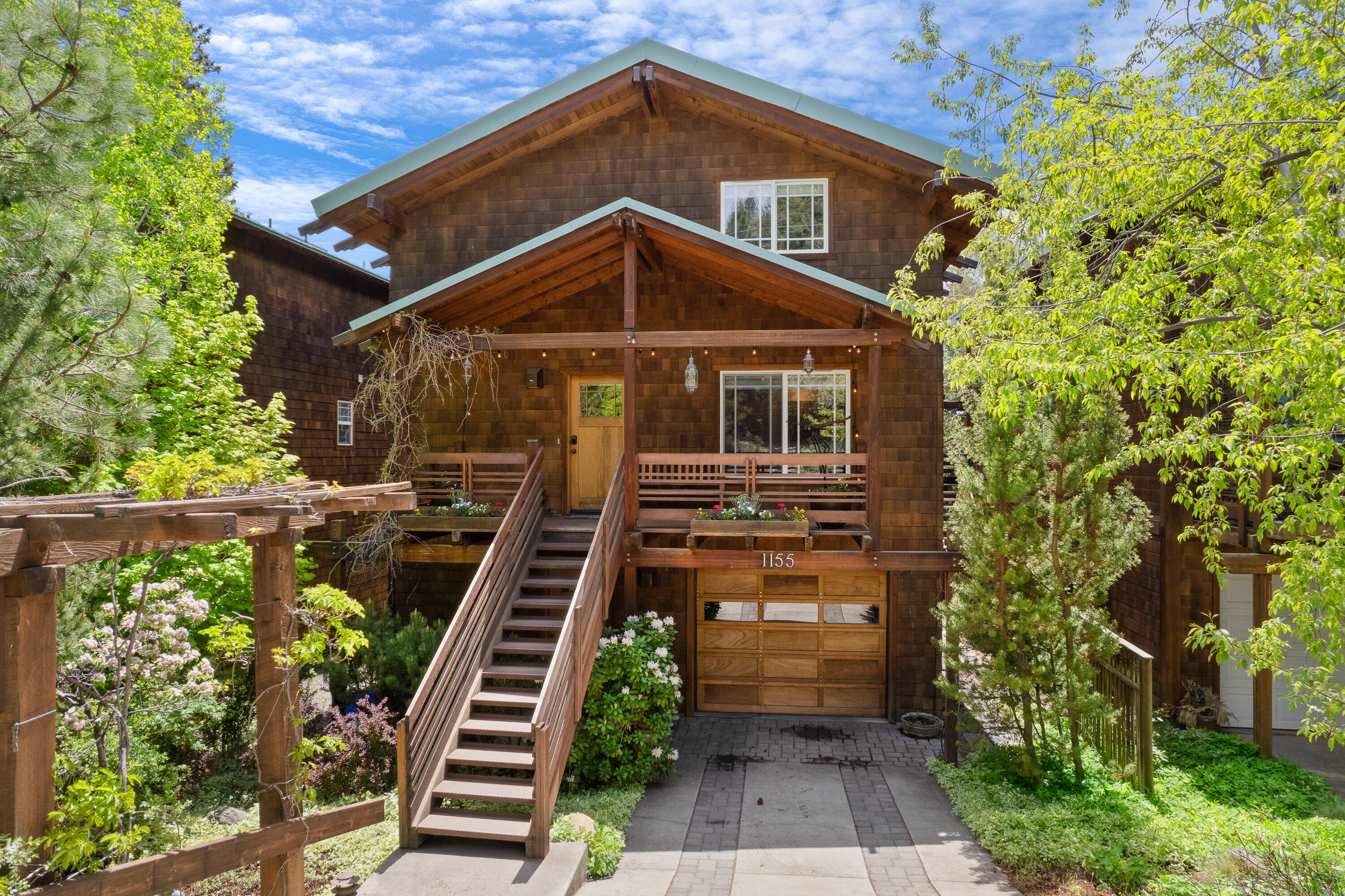 Located in Bend's coveted Westside, this Arts & Crafts style home combines the best of both worlds -- walk to schools, parks, restaurants, shopping yet escape to a serene oasis among the trees. This post & beam home, w/green features, was built with artisanal attention to quality. There are 3 BRs + den, 2.5 baths, & an attached 1 BR, 1 BA apartment, which can be part of main house or locked off as a legal rental unit for extra income. You'll love the exposed wood, natural light, cork floors, 2 gas fireplaces, stainless steel & maple counters, fir cabinets, redwood decks. Main house has new high-end washer/dryer, GE range, dishwasher, microwave; apartment has new range & lighting. Master has walk-in closet and a bathroom w/radiant floor heat & Japanese soaking tub. Other features: heated driveway, operable skylights, southerly views, easy to maintain grounds. Enjoy this gracious retreat in the heart of Bend, close to Newport Market, Hillside Park, off leash dog area, Spork, Drake Park.