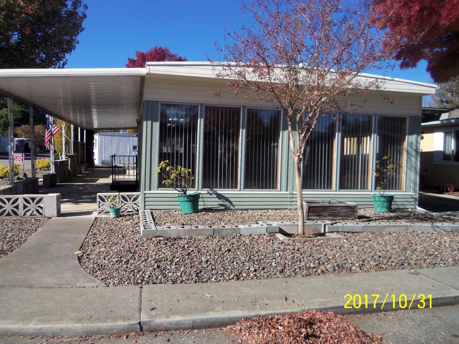 Located in the much desired Aspens on the Creek 55+ park. Move in ready 2b 2b home with many nice feature. Large living room with large windows that provide lots of light. The convenient kitchen has newer appliances and easy to access laundry closet. The paneling and kitchen cupboards are white washed to give a unique look. Dining area with built in buffet. Large master bedroom with two large closets and built in drawers. Sliding door to the patio that could allow some private morning or evening time relaxation. The home features a corner lot with a large covered patio that extends to the length of the home. Carport, garden beds, drip sprinkler system, newer heat pump are other nice features. Very well maintained home. This 55+ park is very nice and offers a recreation hall for your scheduled family gatherings or functions. Buyer must be approved by the park manager.
