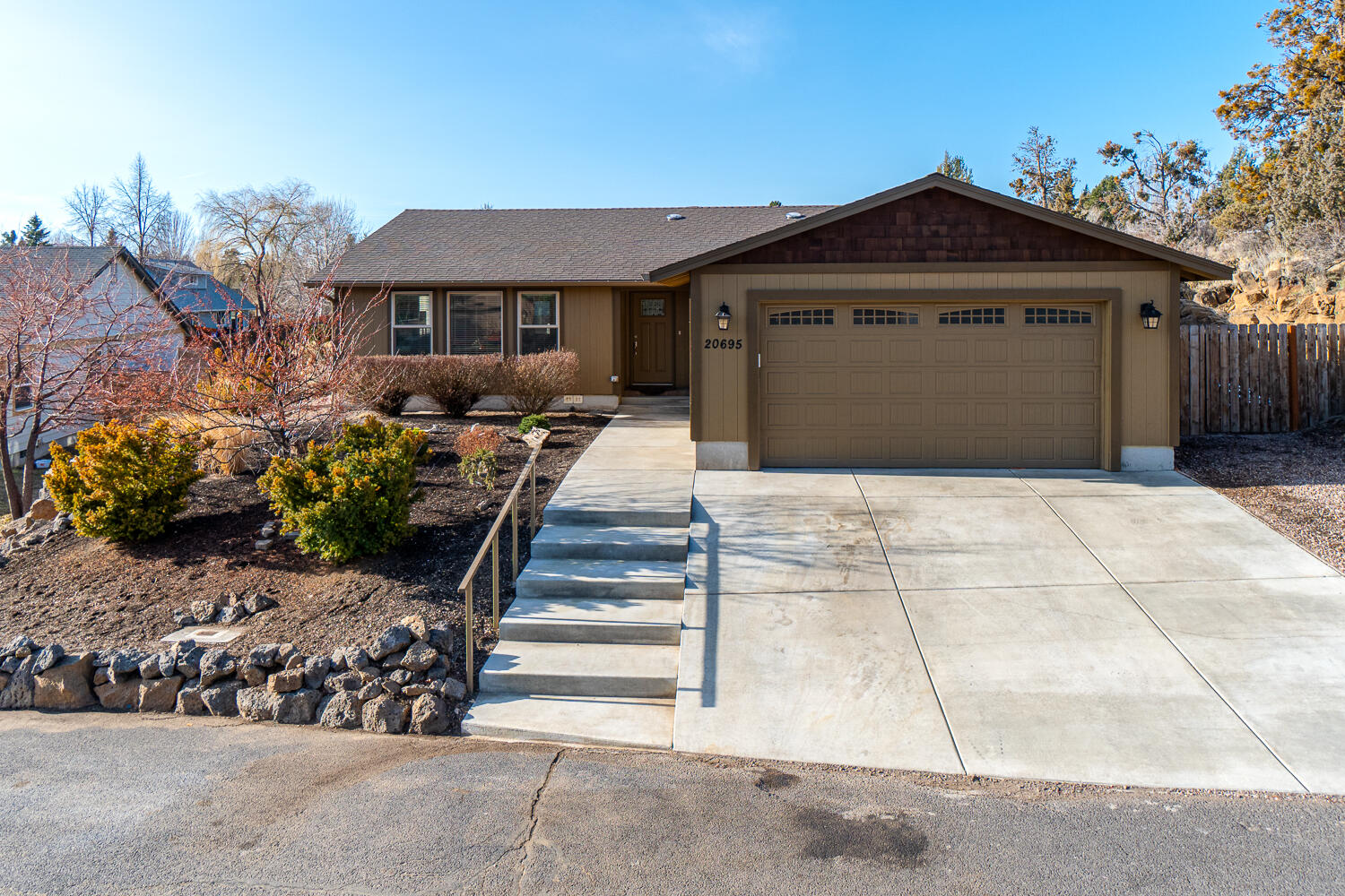 Turn-key home in NE Bend nestled against a lava outcropping in the Vista Ridge subdivision just down the street from Boyd Park. Single level w/Vaulted great room & open floorplan that brings in an abundance of light. Home was completely rebuilt 2 years ago & is like new! Engineered wood look flooring throughout main living areas & bedrooms for a cohesive look & no carpet! Open Kitchen features a lg central island w/breakfast bar seating & granite counter tops & full height backsplash. Modern custom cabinetry w/slow close feature, undercabinet lighting & brushed nickel hardware. Dining area has a french doors that open to the back yard & deck for convenient grilling & entertaining. Primary bedroom is lg enough for a King sized bed w/ a walk-in shower in Primary Bath. Two additional large bedrooms w/ shared bath. Both shower surrounds are solid Quartz! Ductless heating & cooling, the latest efficiencies & a dbl garage & RV space too. Low maint. landscape & move in ready! *SEE OPEN HOUSE