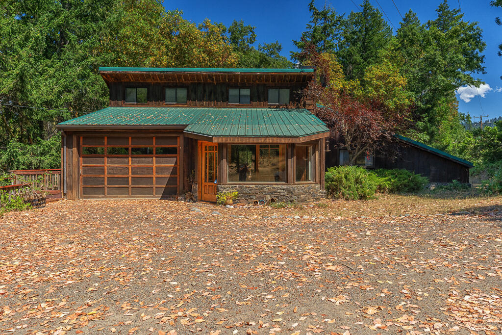 A perfect blend of rural serenity & functional living awaits on this 6.65-acre property just minutes from the heart of Ashland, Oregon. Surrounded by majestic madrone and fir trees, this private retreat offers natural beauty, privacy, and remarkable versatility. The main 2-bedroom, 2-bath home features a thoughtful layout w/an art room, attached garage, and expansive windows that bring the outdoors in. Just steps away, a beautifully finished Accessory Residential Unit (ARU) with a full kitchen is perfect for guests, extended family, or rental income. A unique workshop crafted from 2 shipping containers features hydraulic doors, a professional-grade engine hoist, abundant storage, & an adjacent large covered outbuilding—ideal for makers, mechanics, or outdoor enthusiasts. Whether you're enjoying peaceful mornings under the trees, tackling your next project, or exploring Ashland's renowned theaters, restaurants, and trails, this property offers the freedom to live, create, and thrive!