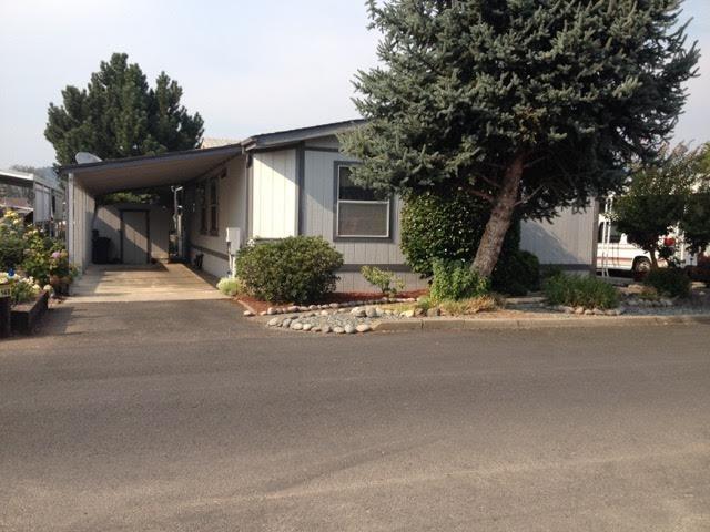 Relax and Enjoy! Water front location in 55+ Rogue Lea Estates. This 3 bedroom / 2 bath Fleetwood Manufactured home has 1568 square feet. Custom built in 1990 with only 1 owner, this beautiful home offers many features including a newer heat pump, walk-in closets in all bedrooms, and a separate laundry room with washer and dryer included. Natural light abounds. Landscaped front and back yard areas with stepping stones to pond front.