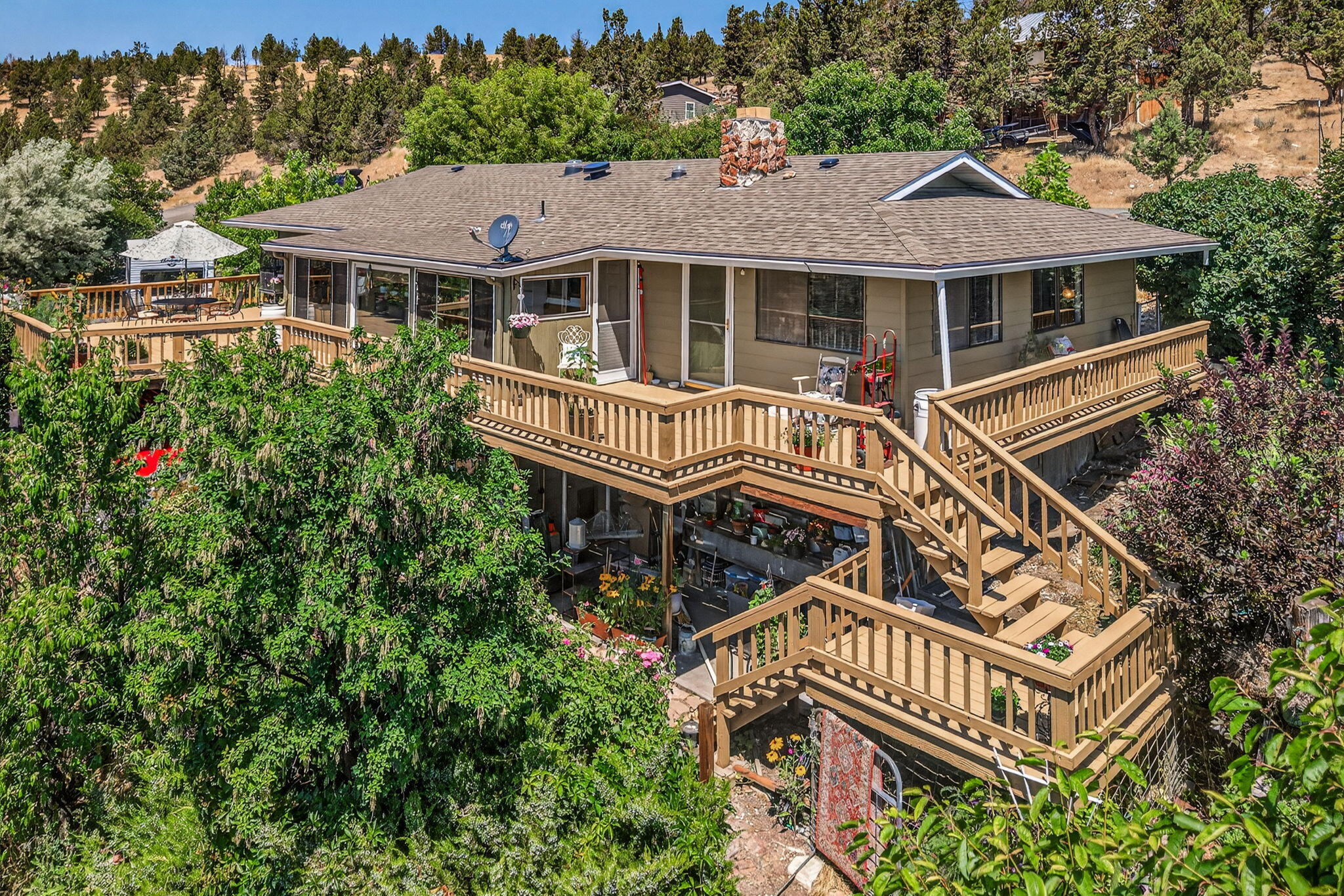 Overlooking the lush farmland and rimrock ridges beyond, this charming and updated 2bed, 2.5bath home offers a perfect mix of peaceful country living and modern convenience. Set on a combined .72 acre triple lot, the property provides space, privacy, and stunning views - just minutes from town. Inside, enjoy a light-filled layout with 2 full baths on the main level and a convenient half bath in the daylight basement - perfect for guests, a hobby room, or added flexibility. Recent upgrades include a new roof in 2021, newer garage door, updated deck, newer heat pump. An attic exhaust fan adds extra cooling. Installed backflow valve at the street protects your water system. Step into the enclosed sunroom year round. Enjoy the spacious yard with mature fruit trees, flowering plants. RV parking with full hookups. Whether you're gardening, relaxing on the deck, or watching the sunset, this home makes it easy to love where you live. Move-in ready, beautifully cared for and full of features.