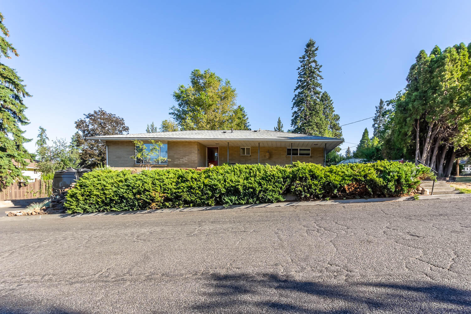 Nestled at the base of Pilot Butte, you will  find a hidden gem located at 1201 NE 9th Street.  An updated 1953 mid-century modern brick home on a corner lot with much to offer!  The updated, entertaining kitchen is a chef's delight!  Equipped with a professional 6-Burner Viking stove, warming lights & industrial hood; live edge floating shelves, new LG Appliances, granite counter tops, butcher block peninsula, lots of storage and a built-in kegerator!  Enjoy many other features such as the hydronic radiant heat flooring throughout, multi-zone wired Sonos system, central vac and new LVP flooring!  Extend the comforts of the home to the outdoors where there are multiple areas to entertain, including the freshly painted back deck, or sit and enjoy 4th of July fireworks from your front porch! There is also dedicated RV parking & hook-ups.  Exterior faucets offer both hot/cold options.  Rounding out all this home has to offer is the finished mother-in-law suite or possible ADU opportunity!