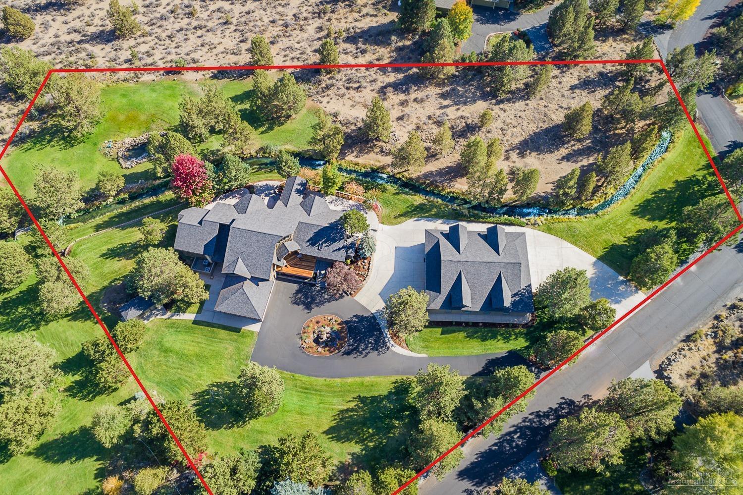 This remarkable, industrial farmhouse is all new...inside & out. The home was completely re-designed & finished w/ no expense spared. Timber framed entry leads to open concept design and reclaimed barnwood throughout. Kitchen has gorgeous quartzite counters, a huge pantry & top-of-the-line Thermador appliances. Main level living w/ luxurious master suite (2nd master lower level). Enormous shop w/ heated floor, RV pkg, kitchenette, bath & ADU potential. Lovely setting on the canal & total privacy on 2.72 acres.