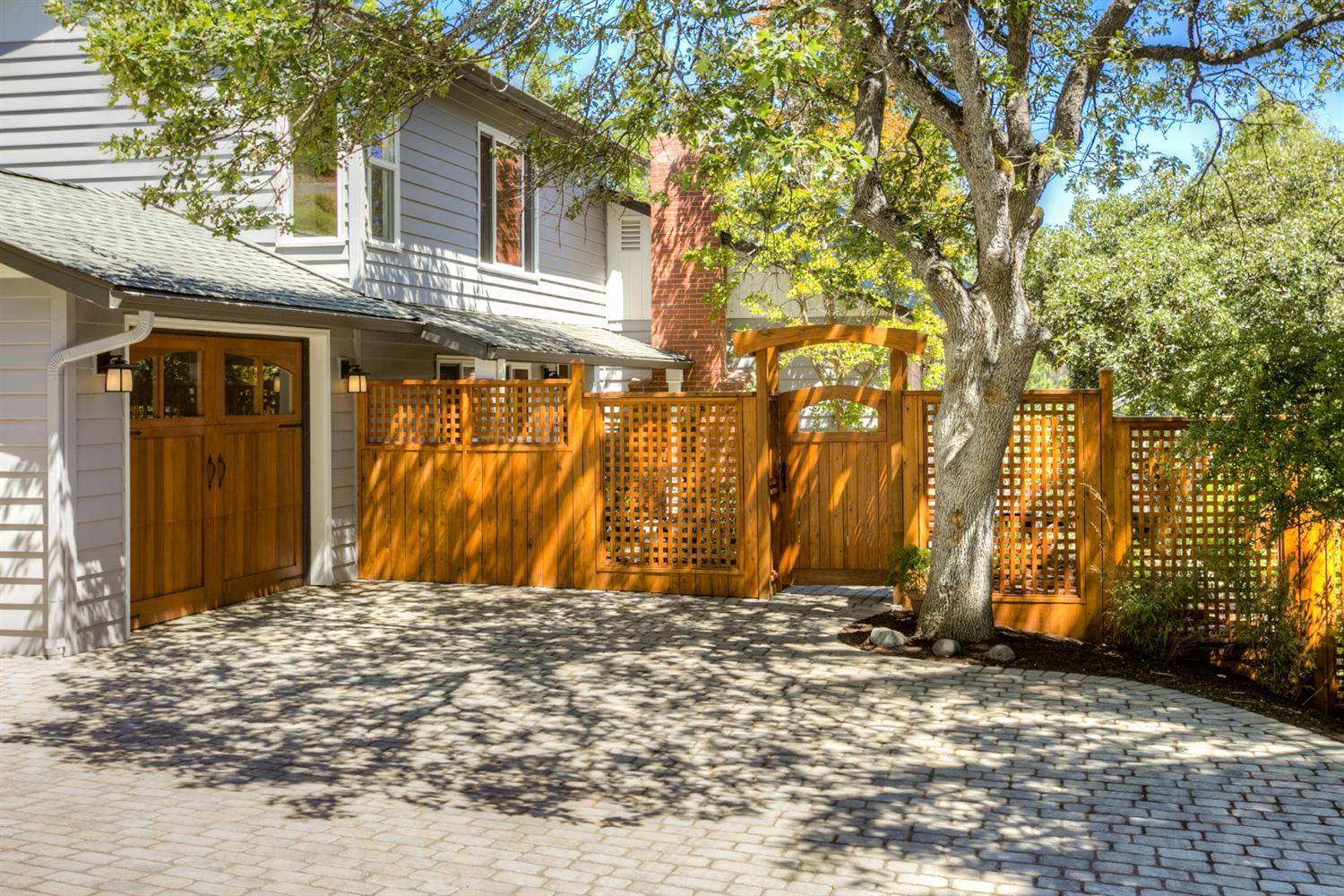 Meticulously maintained and lovingly updated mid-century home with a great location, just blocks above beautiful downtown Ashland. Great floor plan, main level living area (most of which was the original portion of the home) has three bedrooms, one bath, dining area off of the kitchen with a door that leads to the back patio and a wonderful living room that centers around a gas fireplace with brick hearth surround and built-in shelves. The east facing side of the home has lots of windows to capture the wonderful views and allows an abundance of natural light to filter in. There are oak hardwood floors throughout, interior doors and hardware have been replaced, there's a freshly remodeled bathroom and virtually all plumbing throughout is updated. There is a brand new single car garage with additional storage and the list goes on, these are only a few of the many recent and tasteful upgrades. The outdoor living spaces are gorgeous with beautiful plantings, stone walls, walkways, new back