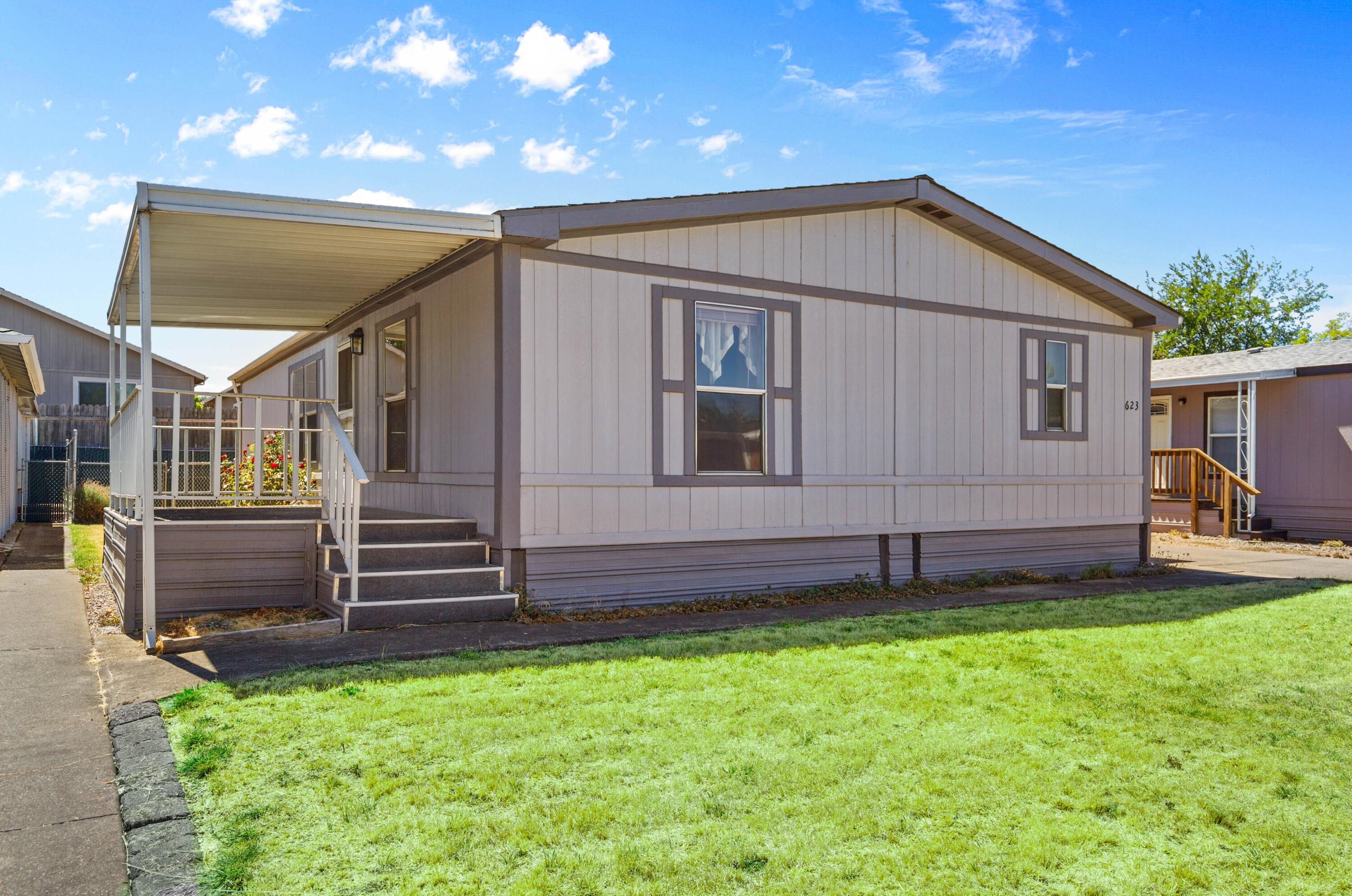 Charming 3-bedroom, 2-bath double-wide manufactured home in Myra Lynne Park, built in 1989 and offering 1,188 sq. ft. of living space. Features include a spacious living room, large kitchen with a split floor plan, laundry room, driveway, covered carport, enclosed shed with 220V outlet, and a fenced backyard. Residents enjoy a clubhouse, swimming pool, sauna, basketball and tennis courts, playground, and beautiful park-like setting. The park hosts two annual garage sales with follow-up dumpster days and sometimes provides landscape bark for residents. Because the park owns its own power and water, it is often able to pass savings on to residents. This home combines comfort, convenience, and community living! Schedule a showing today.