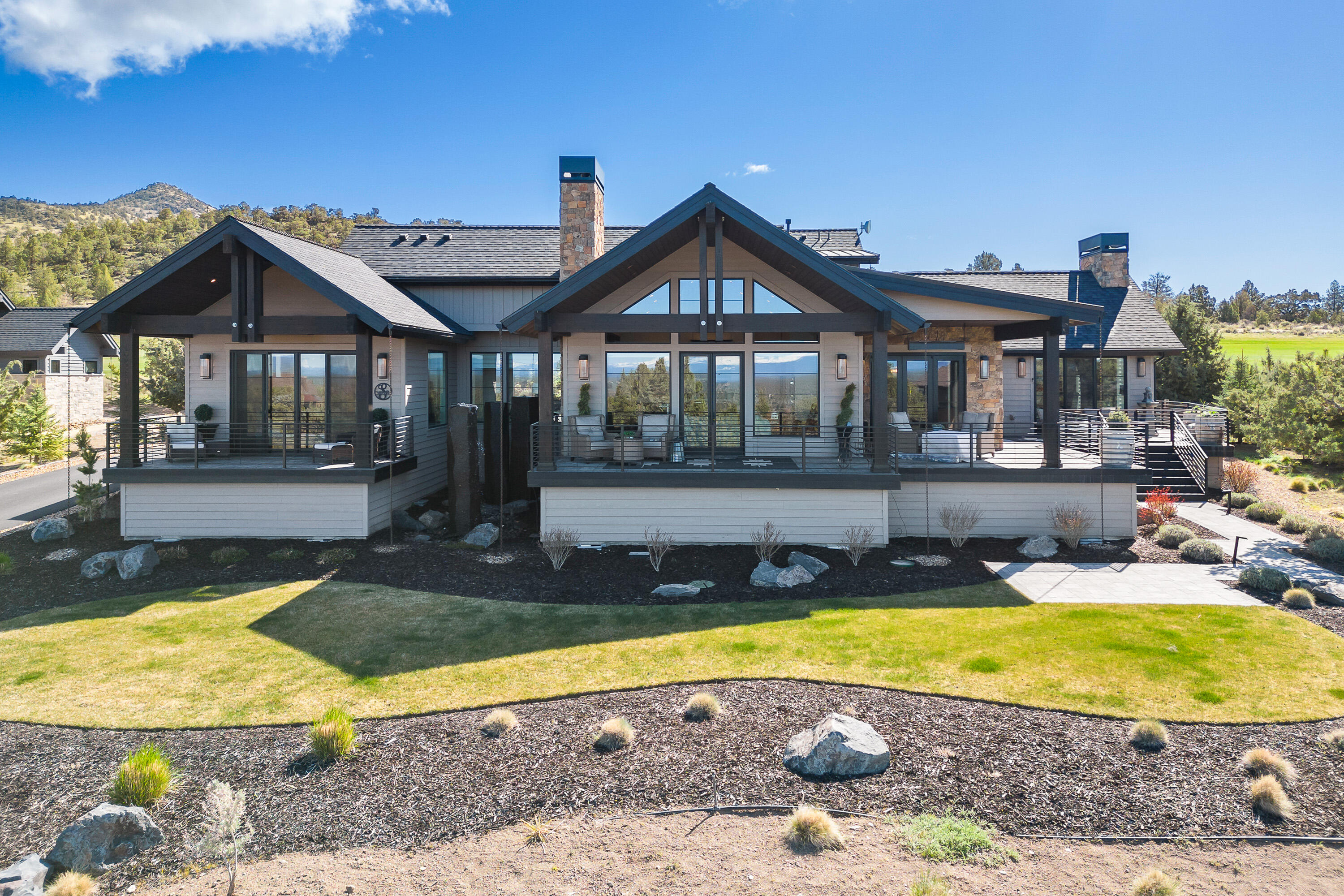 Indulge in the epitome of Central Oregon luxury living with this breathtaking residence. Nestled amidst the serene beauty of the landscape, this architectural masterpiece commands attention with its stunning Craftsman/Northwest style design.
Step inside to be greeted by an inviting expanse of space, where natural light pours through expansive windows, illuminating the grandeur of the great room. Crafted with meticulous attention to detail, the built-ins add both functionality and charm, while the adjoining dining area sets the stage for unforgettable gatherings.
The heart of the home, the kitchen, is a culinary enthusiast's dream, boasting a sprawling slab island, gleaming stainless steel appliances, and a walk-in pantry. Whether hosting intimate dinners or grand soirées, this space is perfectly suited to meet every entertainment need. Outside, the allure continues with striking vistas of the 7th fairway and  sweeping panoramas of the Cascade Mountains to the front. Your home awaits