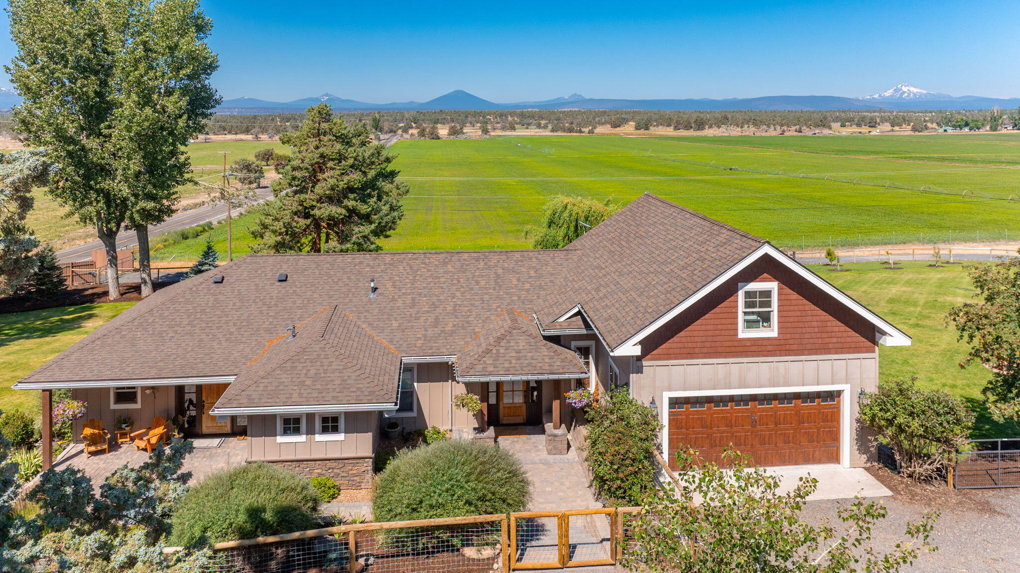 Nestled at the foot of the majestic Cascade Mtns in CO's high desert, this 40±ac ranch, with 30.6 irrigated ac, offers the ultimate in rural living, blending sustainable self-sufficiency, equestrian potential, and refined hobby farm. This property delivers panoramic Cascade Mtn views, sweeping high desert vistas, big sky sunsets. It's ideal for those seeking privacy and outdoor recreation. Ready for livestock, hay production, horses, vegetable garden, mature fruit orchard, pastureland w/leased income, and a spacious shop/barn w/room for machinery, tools, or stables. Indoors, unwind in luxury with updated gourmet chef's kitchen, cozy fireplace, hot tub overlooking breathtaking panoramas and eco-friendly lifestyle. Minutes from world class rock climbing, hiking, fly fishing, tranquility under CO's endless blue skies and timeless peaks, and amenities in Redmond and Bend,. This ranch embodies rural homestead dreams: sustainable, horse-friendly, irrigated farmland w/endless potential.