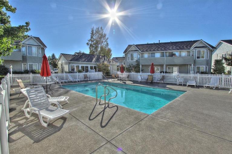 This is a good one! Start with the great neighborhood location, then add a clean and quality home with plenty of nice features. Inside it's bright with many windows, some tinted. The great room has a vaulted ceiling and ceiling fan, plus a gas fireplace with mantle. The open floor plan includes an updated kitchen and appliances, including microwave, dishwasher and smooth cooktop. There are beautiful solid oak cabinets. Enjoy a private covered patio with much greenery. Monthly dues cover pool, but is still quiet. Master bedroom features a walk-in closet, and there's extra storage in the garage. This is a great combination-you get your own private home, while someone else takes care of the exterior, including lawn maintenance!