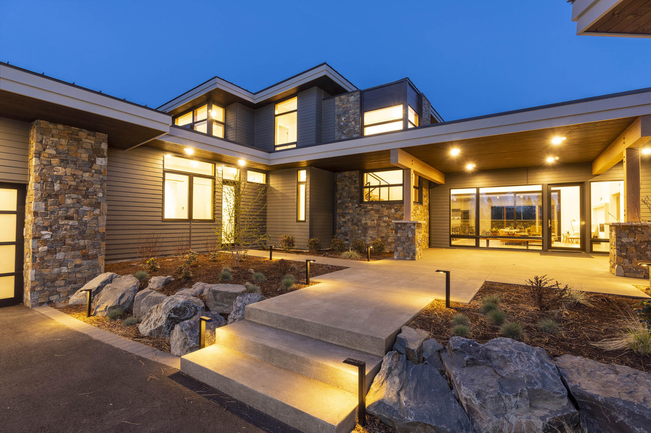 Set on the rise of a premium lot in Tetherow, this stunning contemporary estate blends seamlessly into the high desert landscape. Soaring ceilings & clerestory windows usher in full-day indirect light. Open the oversized sliding glass doors to the private patio w/ fire pit & hot tub. The spectacular kitchen is a chef's dream, w/ authentic Caesarstone countertops, Wolf & Sub-Zero appliances, 2 Miele dishwashers, & abundant storage space. Owner's suite on main boasts patio access & a spa-like bath w/ heated floors, an oversized custom soaking tub, & double vanity w/ Caesarstone counters. An expansive W/I tile shower features dual rain shower heads & hand showers. Four more bedrooms, including 3 en-suites, can be found on the other wing of the home. Enjoy a main-level media room with patio & upstairs flex room w/ access to the large back deck w/ golf and mountain views. Other features of this incredible home include an oversized 3-car garage w/ deep bays & a large laundry/mudroom.