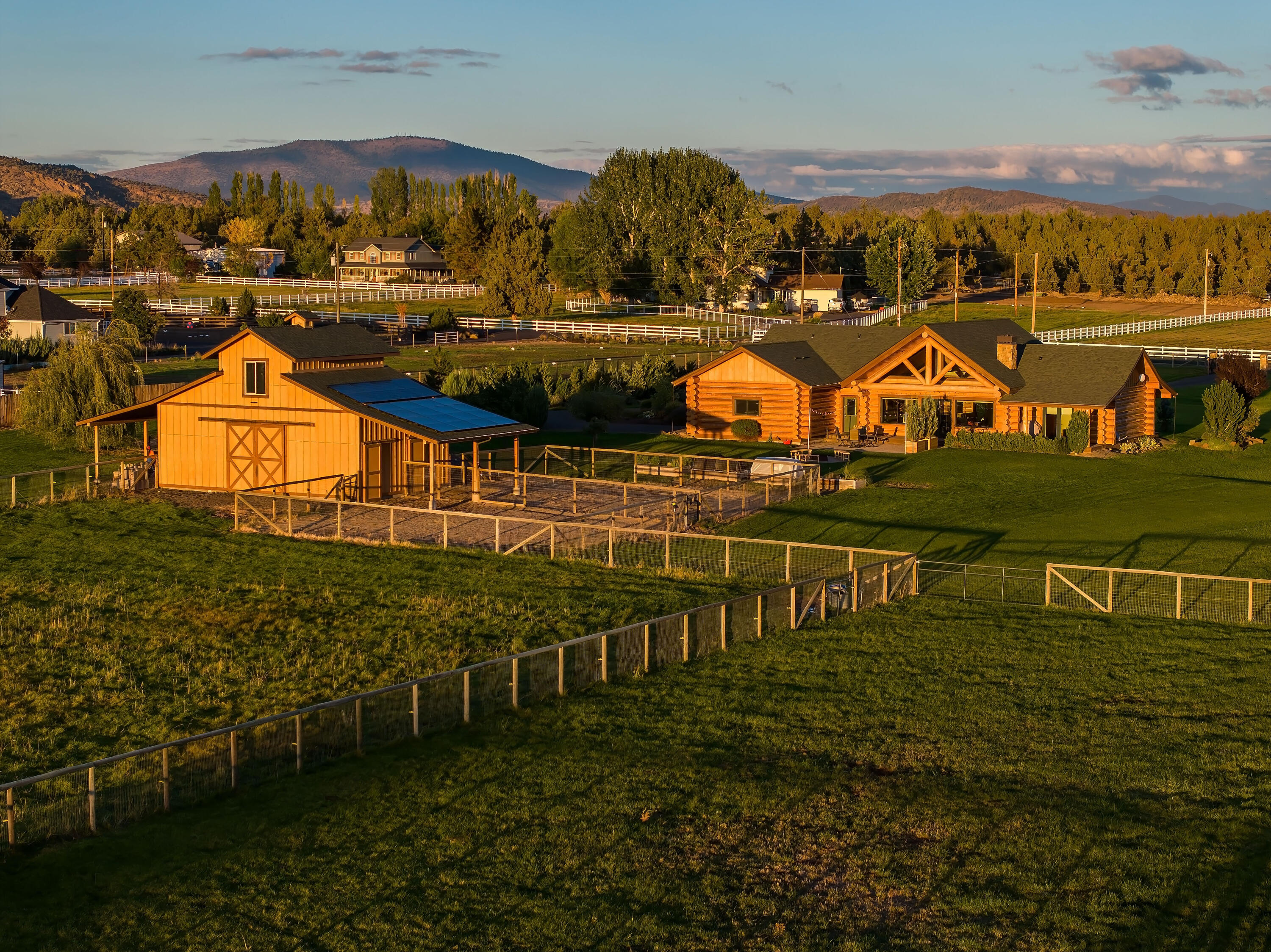 Discover your ideal Central Oregon property in the highly sought after Equestrian Meadows, suitable for horse lovers and those seeking a country lifestyle near Redmond, Oregon! This stunning, single-level log home offers comfortable, luxury living space on 6 acres+underground irrigation, & open, expansive views of the Cascade Mountains! This custom-built home features a fully-owned Solar System, Central Vac, private primary suite with French Door accesses to the back deck, and an impressive Great Room area with everyone's Dream Kitchen space! Upon property entry through the iron gate, you'll notice this gorgeously manicured estate, cross-fenced and complete with a 2 stall Barn + heated Tack room & Pasture. Property has plenty of room for privacy, storage, outdoor leisure w/ a Cozy Fire Pit, and space for animals. Soak in the scenery from the covered Trex front and back porches, perfect for relaxing or entertaining. Don't miss the RARE opportunity to live in this coveted neighborhood