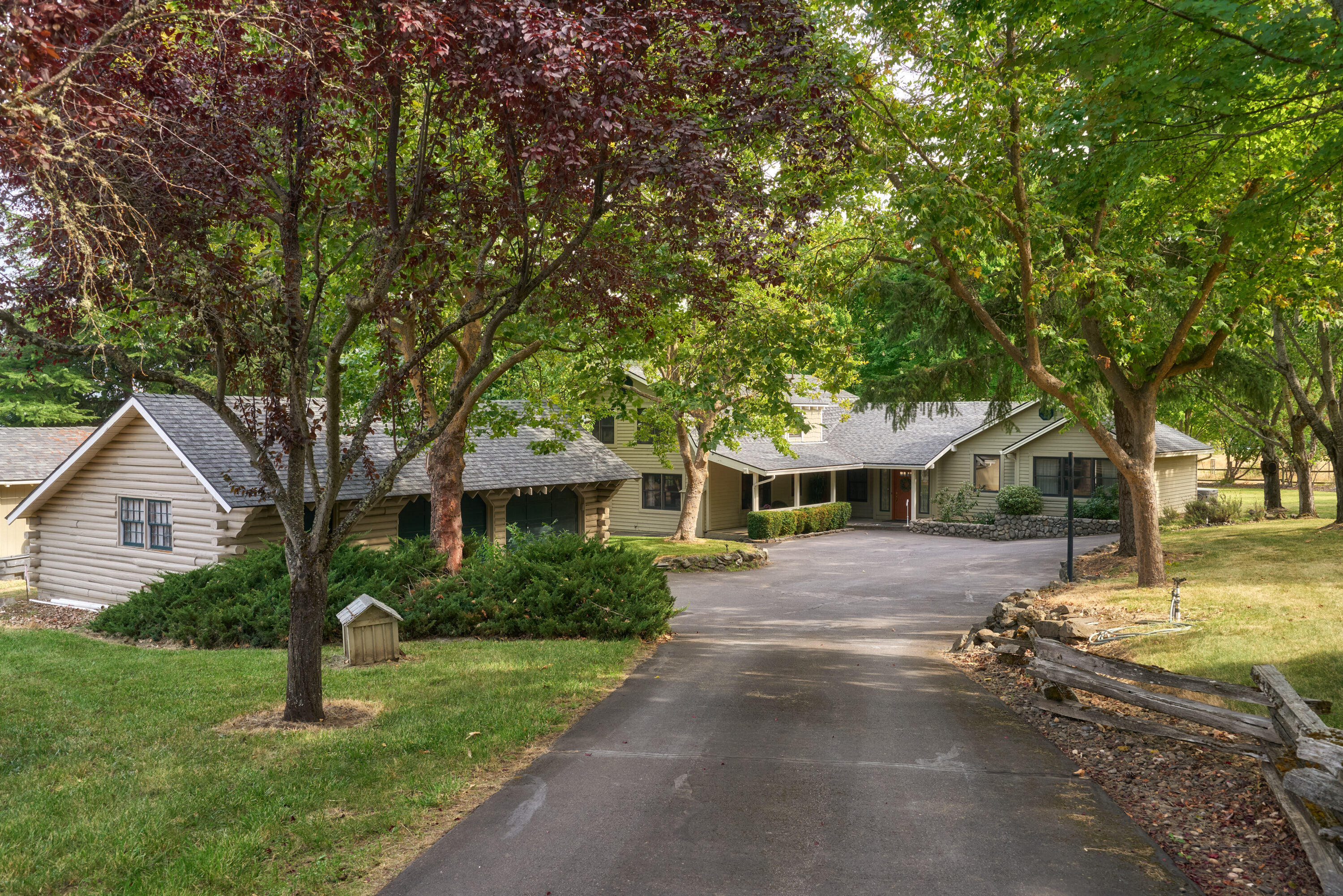 This stunning 4-bed, 3.5-bath home offers 3,540 sq. ft. of thoughtfully designed living space on approx. 5 private, usable acres with EFU zoning. The property includes over 4 irrigated acres (TID), ideal for hay production, grazing, horses or other animals. Featuring two primary bedrooms, including one on the main level, and an open kitchen with island and abundant storage, this home offers both comfort and style. Additional features include a detached 2-car garage, barn with 3 horse stalls, tack room, and hay storage. The property is complete with a large deck perfect for outdoor living, mature landscaping, and ample natural light throughout. A gated entry and paved circular driveway provide privacy and ease of access, while being conveniently located near Griffin Creek School and Medford's southwest hills.