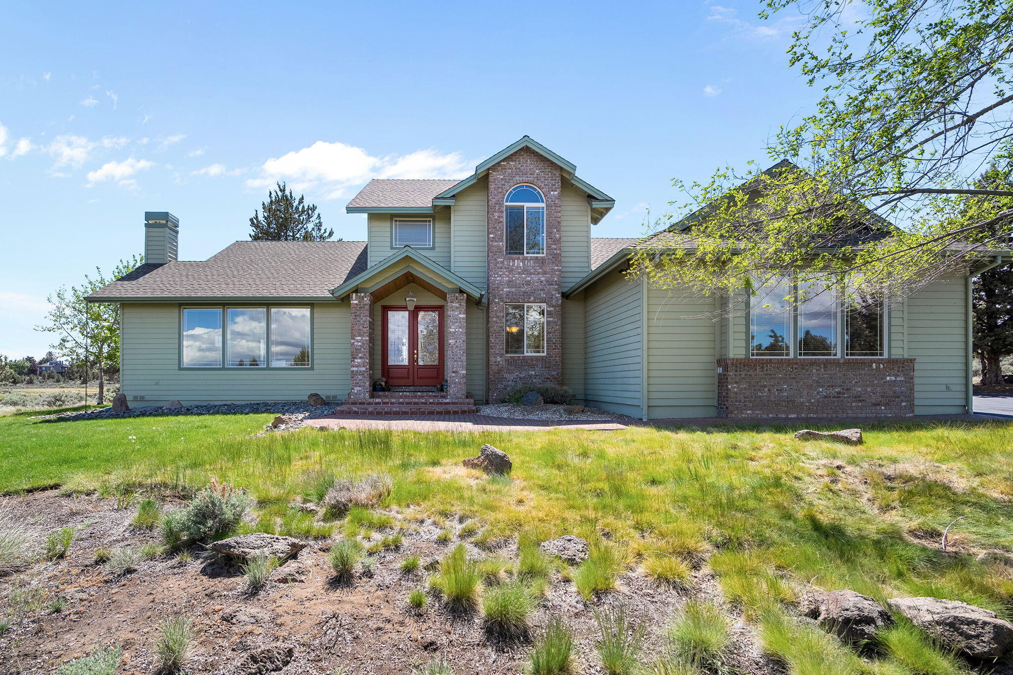 Set on 2.23 peaceful acres in Bend's desirable Lane Knolls Estates, this immaculate home offers the perfect blend of privacy, space, and natural beauty—backing to green space for added serenity. With 2 bedrooms, 2 full baths, a versatile loft, and a flex room that could be a 3rd bedroom with its own half bath, the layout is ideal for both work and relaxation. Multiple living areas include a welcoming living room, cozy family room, formal dining, and a bright breakfast nook. The kitchen features abundant storage and a large walk-in pantry, perfect for the home chef. Upstairs, the private primary suite offers sweeping views and a spa-like bath with tub, tile shower, and dual vanity. Step outside to enjoy a beautifully landscaped yard with a fenced area for pets or gardening. A spacious 3-car garage provides ample room for vehicles and gear. Located in a quiet, established neighborhood just minutes from town, this property offers the best of Central Oregon living.