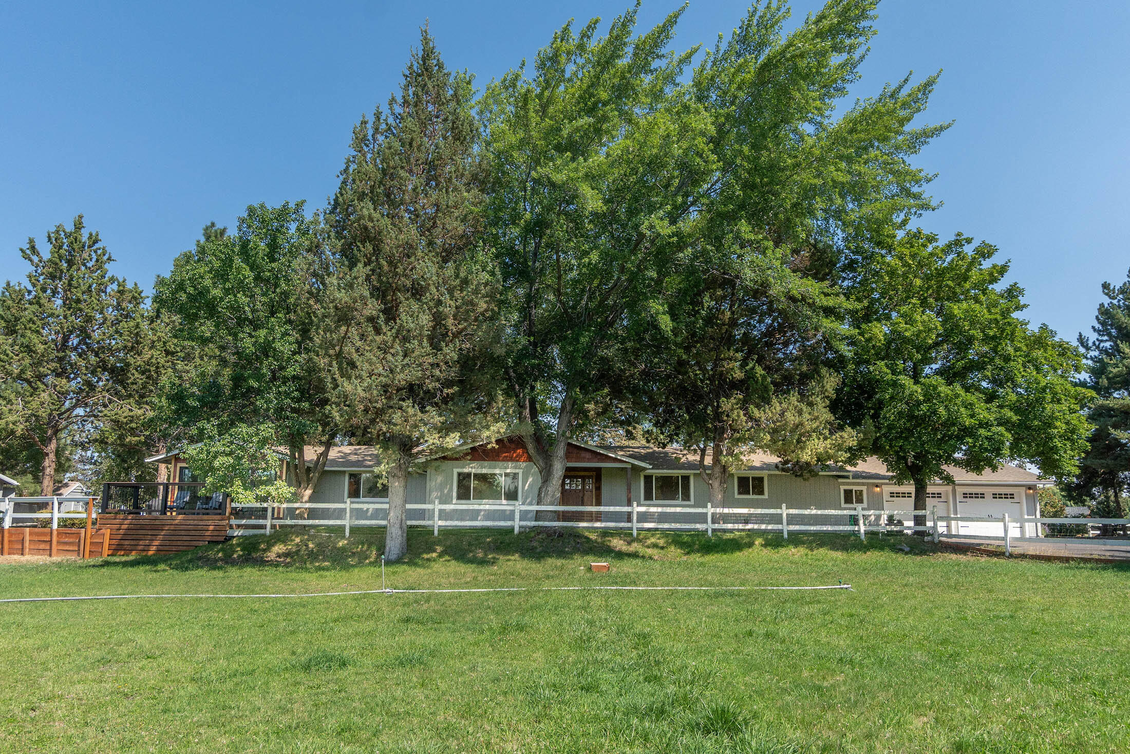 Discover a remarkable 10.4-acre hobby farm with a fully renovated 2,442 sq ft single-level ranch home. This gem features 4 beds, 3 baths, open concept, LVP flooring, high efficiency heating/cooling & Gourmet kitchen w/ Dacor appliances & soapstone waterfall counter. Glass bifold door for indoor/outdoor living. Primary with walk-in closet & updated tile shower. Multiple patios, wrap-around driveway & 440 sq ft building for an ADU conversion. 9 acres of irrigation, garden, shed, chicken coop & dog run. Barn with four stalls fenced and cross fenced for Horses or Livestock. Irrigation pond on property fed by district. 5 mins to eastside shopping & close to Badlands Wilderness. Don't miss this serene farm living!