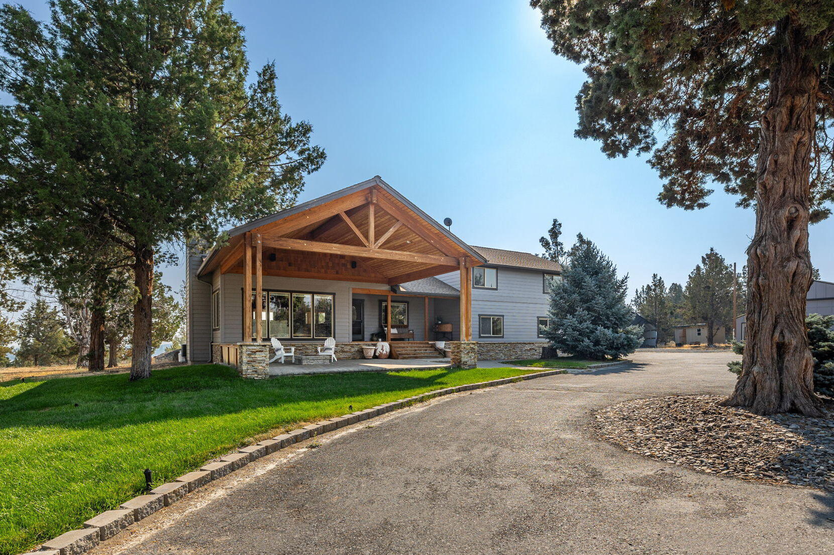 Situated in the heart of Tumalo on a private 9.81 acre property w/one acre of irrigation, this charming home features thoughtful updates throughout & stunning views of the Cascades & Ochoco Mountains. Great Rm with a wall of windows overlooking the Mts, offers vaulted pine ceilings, hickory flooring & wood burn fireplace. Chef's Kitchen w/slab granite countertops, maple cabinetry & walk-in pantry, opens to dining w/access out to covered back deck and breathtaking easterly views. Upstairs: Primary w/remodeled BA & private balcony. 2 additional BR + updated 2nd full BA w/soaking tub & tile flooring. Multiple outdoor spaces including a PHENOMENAL covered front paver patio w/gas firepit...the perfect place to entertain or relax looking out to the mountains. Attached 2 car garage PLUS detached shop for all your Bend gear. Additional 400 SF flex space adjacent to shop ideal for a secluded Office/ Bonus Rm. NO HOA. MOTIVATED SELLER!