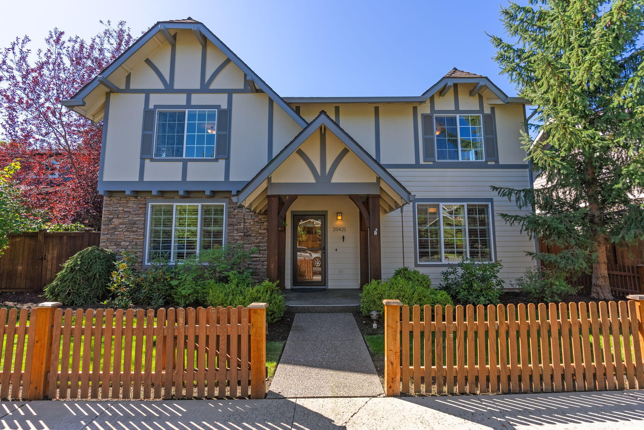 Loaded with designer touches and sought after floor plan features, this exceptional home is located in Stonehaven in Bend's thriving SE section. With four bedrooms, including two primary suites, an office and a bonus room, this home offers incredible flexibility. Graced with classic architectural and design elements including plentiful built-ins, leaded accent windows, wood bannister and crisp white accent paint, this home also features updated quartz counters, tile backsplash and tile fireplace surround. On the upper level, in addition to the second primary suite and two additional bedrooms, you'll find a large bonus room with a convenient wet bar and a dedicated office space with work counter and abundant storage. The fully fenced backyard includes a soothing water feature and an expansive patio with a large covered section, perfect for outdoor meals and summer gatherings. Stonehaven is a quiet, established neighborhood with easy access to nearby golf courses, schools and parks.
