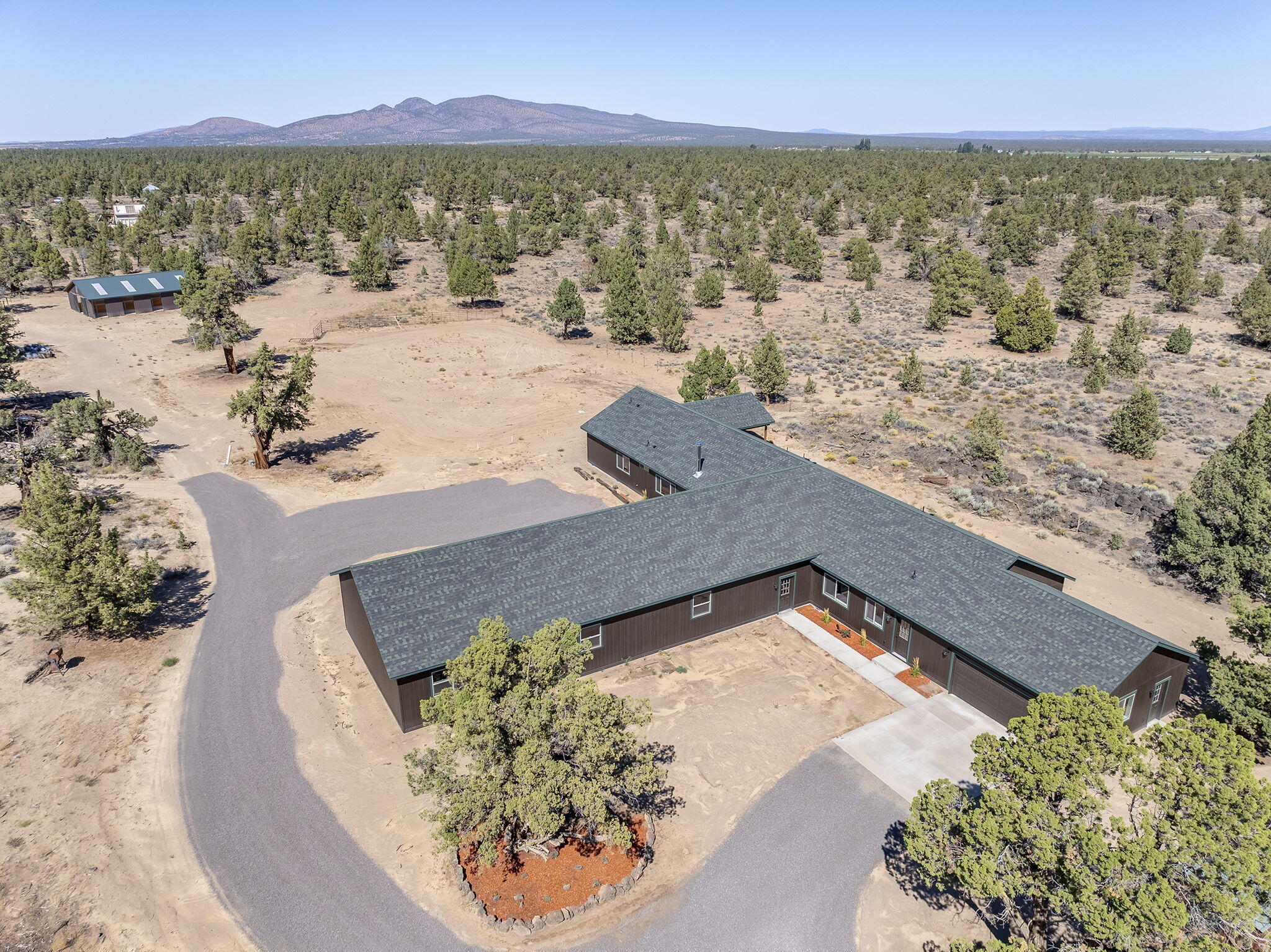 This newly completed single-level home offers the ideal combination of privacy, flexibility, and lifestyle. Set on 4.4 acres at the end of a quiet country lane, it provides room to breathe and space to personalize. The thoughtful, versatile floor plan easily accommodates multigenerational living, guest quarters, or dedicated areas for work and hobbies.

Two oversized garages with workshop space and a bonus room offer ample storage and utility. Equestrians and animal lovers will appreciate the 8-stall barn, room for dry lot turnouts, and nearby access to BLM land with miles of riding and recreation trails. 

Whether for horses, hobbies, or simply the peace of country living, this property delivers both comfort and opportunity—just 20 minutes from Bend.
