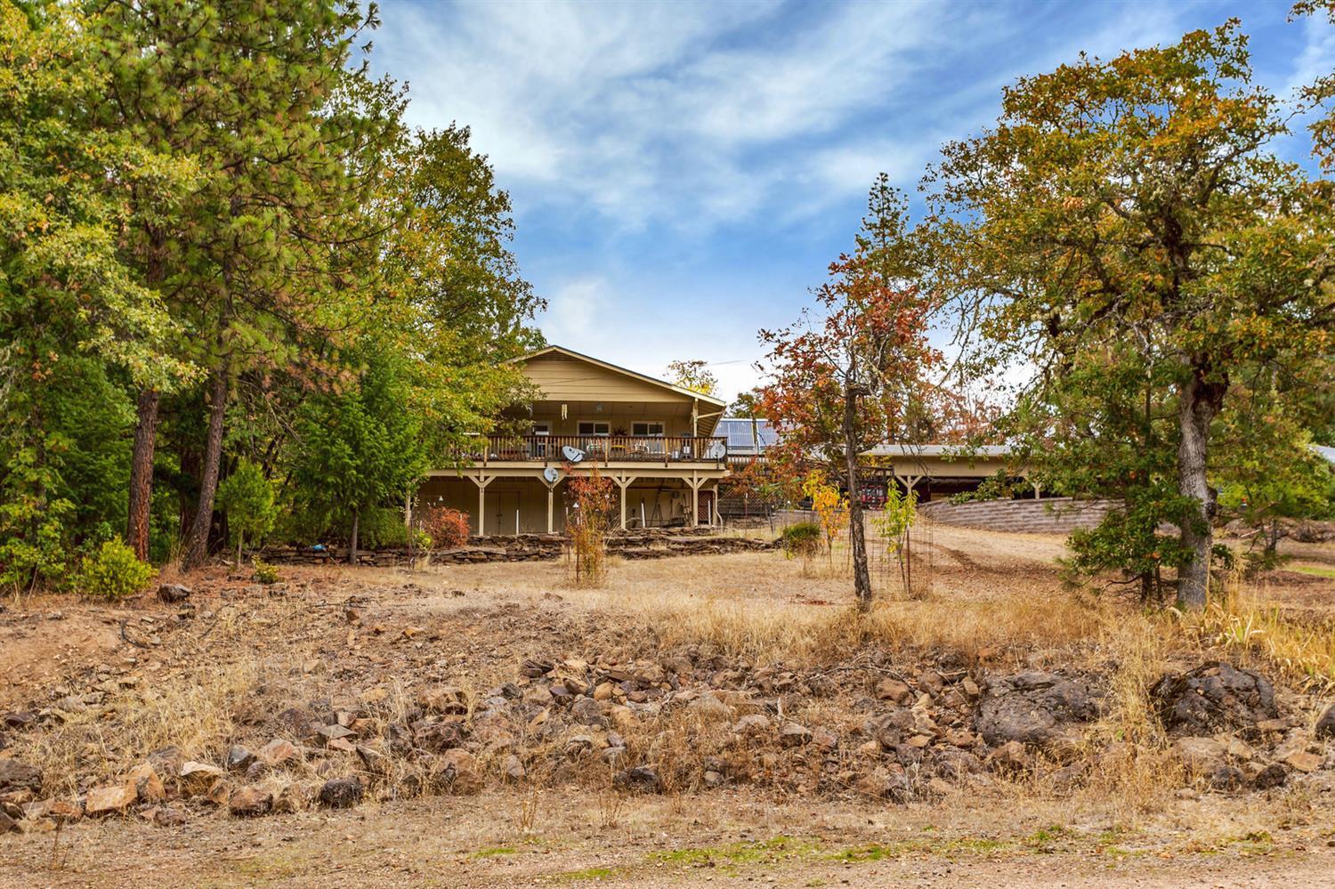 End of the road privacy and seclusion with breathtaking views and abundant wildlife. Almost 80-acres with 2-homes. Main home is over 2,400-sq. ft., 4-bedroom, 2-bath and many upgrades including granite countertops, pull-out cabinets, woodstove, granite trimmed fireplace and large master bedroom with its own private deck. A large carport with storage galore, along with countless other amenities surround this wonderful property. Down below the 2nd house contains 2-huge bedrooms and 2-baths and is 1,600-sq. ft. Nice decking and garden area with great views as well. A very large pole barn, seasonal pond and driving range are also on the property. Included is a VERY extensive solar power system with back-up generators for everything the property has to run. Total fuel used last year was less than $500. The homes, water heaters, well and even the front gate are all powered by solar. No room to list all that this home has to offer, call for a showing today.