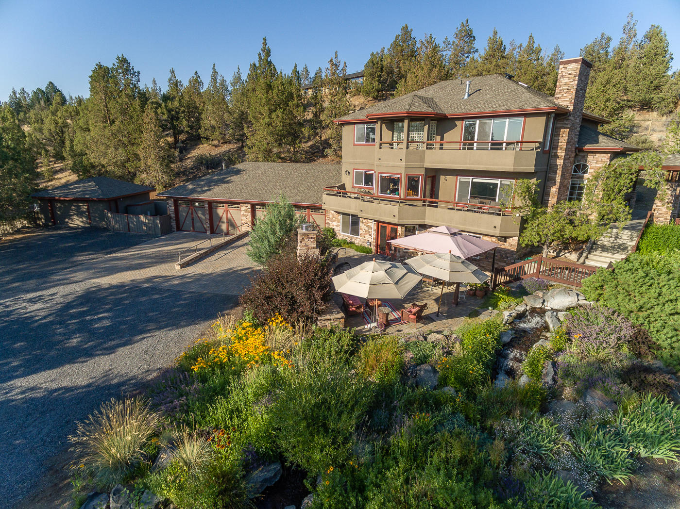 Rare Tumalo custom home with amazing mountain views on private 3.41 acres. 4,412 Sq.Ft. contemporary style home built to take full advantage of the tranquility and peacefulness of this beautiful property. Master suite with mountain views, partially covered deck, fireplace, jetted tub, walk-in shower and 2 walk-in closets. Large guest suite with walk-in closet and updated full bath , 2 additional bedrooms and 2 updated full baths. Open great room with gas fireplace, spacious kitchen and mountain views from every window. Flex space with built-ins that leads to side patio. Downstairs bonus room with full bar for entertainment, gas fireplace and additional storage room and mudroom. Gorgeous outdoor paver patio with large stone fireplace and cascading water feature. 5 oversized garages with heat, water, built-ins and an additional ¼ bath. RV parking with hook-ups, shop/barn and corrals. Lush lawns with separate garden area and large pond. Too many features to list, this home is a must see.