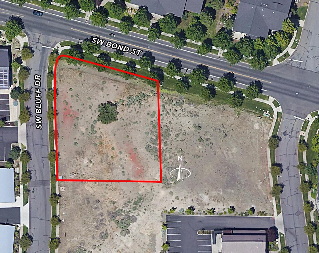 Exceptional mixed-use development opportunity in the heart of Bend's vibrant Old Mill District. This 0.54-acre parcel is zoned Mixed-Use Riverfront (MR), allowing for retail, restaurant, multifamily, hospitality, or office uses. Land use approvals are already in place for a nine-unit townhome project (conceptual renderings available), streamlining development timelines. The site is graded and retaining walls have been completed, with utilities ready for service, offering a true shovel-ready opportunity. The property's corner location provides mountain and river views, with high visibility and excellent access from SW Bond Street and SW Bluff Drive. Located in an Opportunity Zone, the property is suitable for outright sale or joint venture.
