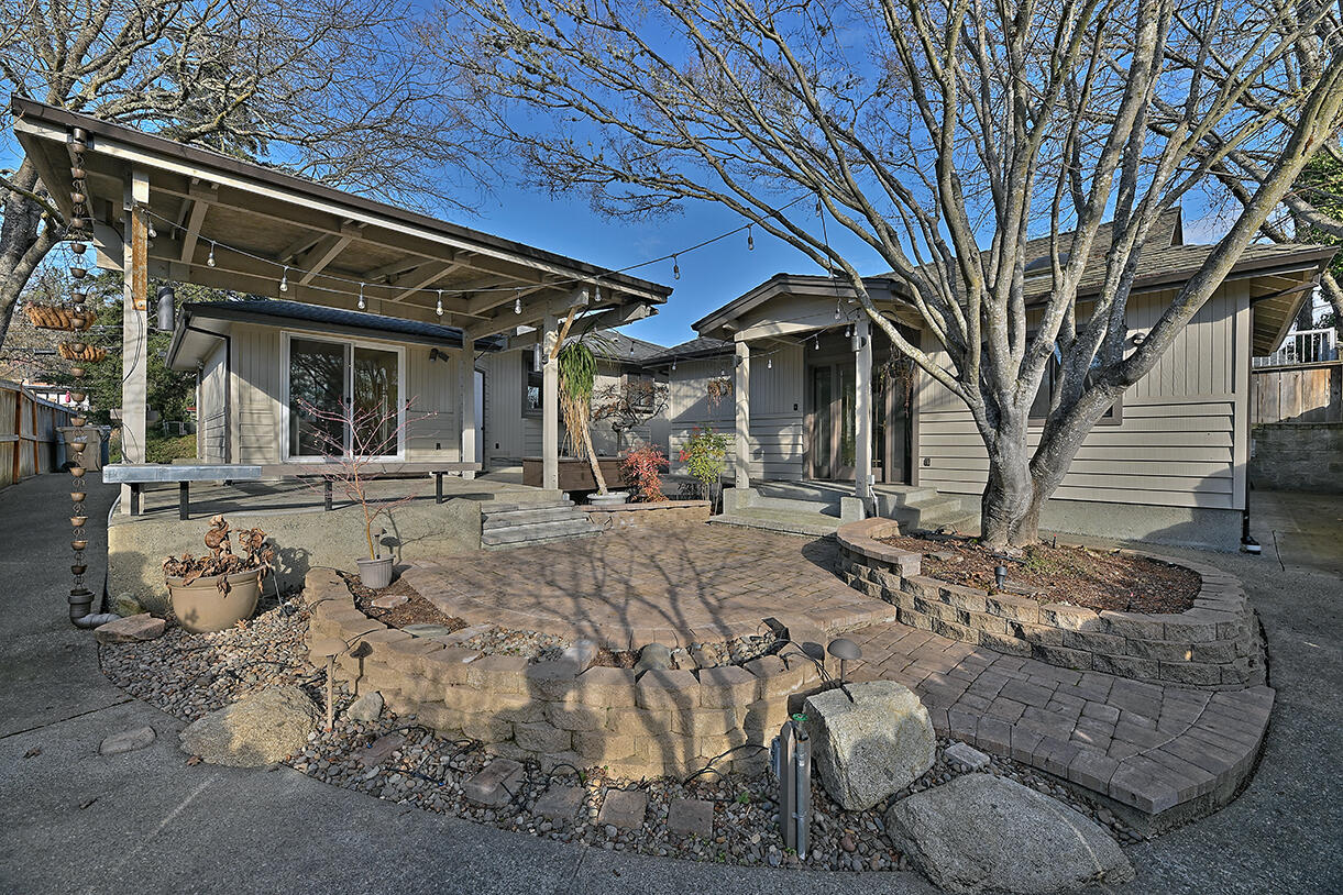 This beautifully maintained 3-bed, 2-bath home offers 1,192 sq ft of updated living space on a manicured 0.14-acre lot in desirable NW Grants Pass. The main home features ductless heating/AC, a newer roof, updated siding and paint, plus gorgeous landscaping and hardscaping. Inside, enjoy marble kitchen counters and backsplash, a neutral color scheme, and laminate flooring throughout the living areas. Outdoors, entertain or relax in the spacious yard with RV parking, ample side-yard storage, a rollup-door unit, and workshop. The standout bonus? A charming accessory dwelling unit with kitchenette, full bath, and large walk-in closet — perfect for multi-gen living, guests, or rental income. This move-in-ready property is a rare gem!
