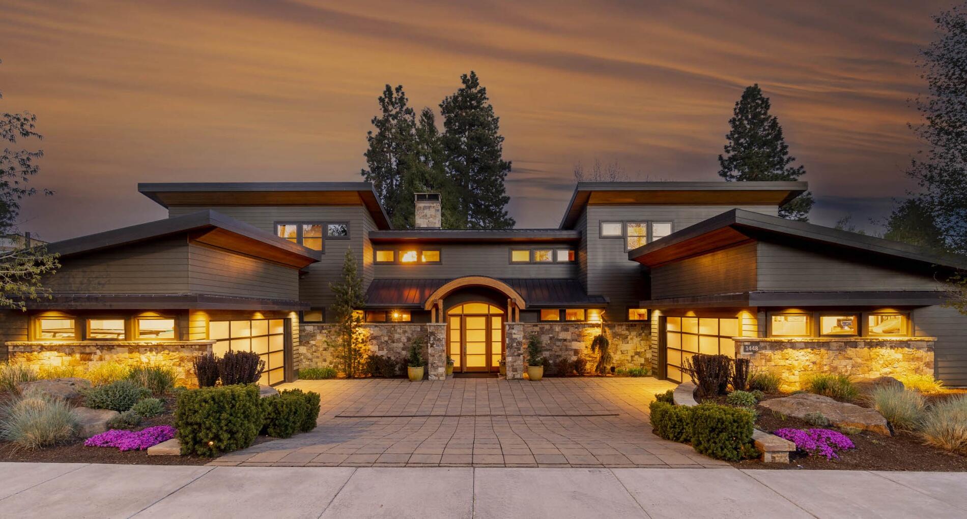 Whether you seek to live in the heart of it all, or are looking for a retreat away from the hustle & bustle of Bend, you'll find it here on First Street. This mountain-modern home blends extensive fir, & stone accents, w/ concrete, recycled glass, & oil-rubbed metal features. An expansive wall of windows extend to the two-story ceiling & frame the river views. Bifold doors open wide to usher in the soothing white noise of the First Street Rapids. The kitchen is a chef's dream, featuring concrete counters, custom walnut cabinetry, & top-of-the-line appliances. The main-level owner's suite features a gas FP & bifold doors to the back patio w/ Marquis spa & custom sauna. In the lower level of this home, find a huge media/game room, 800+ bottle wine room, & hobby room. Three more ensuite bedrooms are on the upper level. On the covered patio, enjoy a built-in grill & bev. fridge, patio heaters, & fireplace. A large lawn spans the 100 feet of river frontage. This home is a sanctuary!