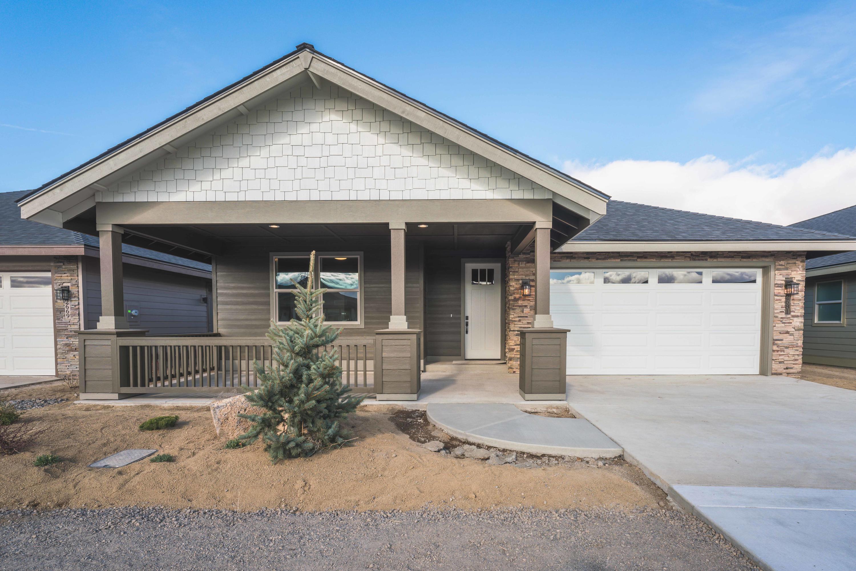 Dry Canyon Village, Central Oregon's premier age restricted gated community.  Enter the single-level Snowberry through the covered front patio into the spacious foyer.  Just off the entrance is the second bedroom space well suited for overnight guests adjacent to a half bath.  The master suite features a walk-in closet, double vanity sinks and private water closet.  The great room is open to the kitchen that boasts solid quartz counters, undermount sink, an island with breakfast bar, walk-in pantry and a large dining area to host dinner parties.  A sliding glass door leads to the covered back patio perfect for entertaining guests.  A laundry room with utility sink and counter space is just off the double car garage.  An additional workshop space in the garage is perfect for home projects and hobbies.  An upgraded trim package with fully wrapped windows, vinyl plank flooring and abundant storage throughout the home finishes the interior.   A backyard fencing option is available.