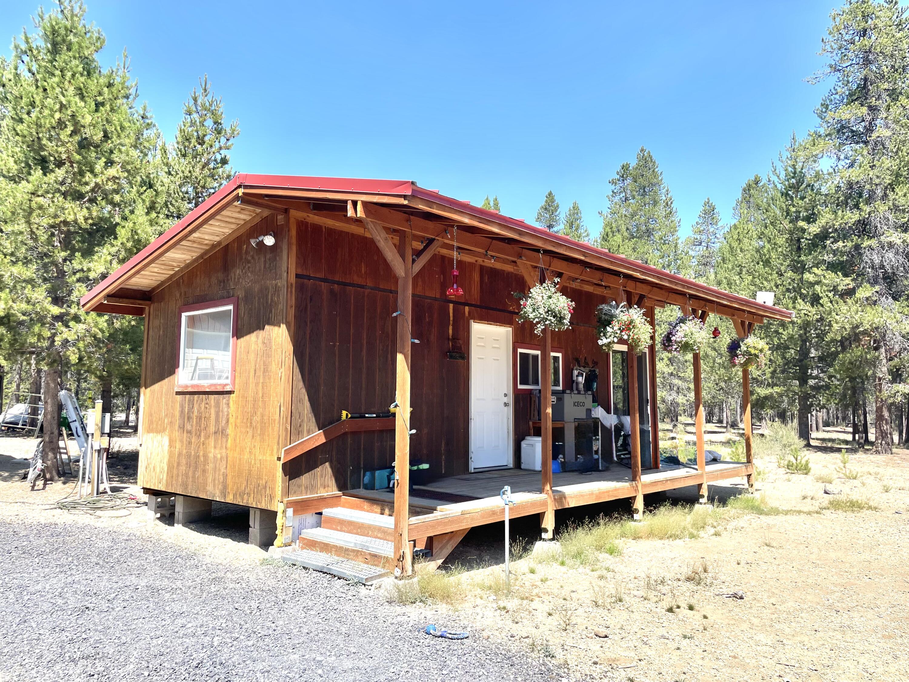 Find your perfect vacation spot on this 5.04-acre property next to forestland with access to Three Rivers OHV trails. Whether you want a peaceful escape or outdoor adventure, this property suits your needs. The 319 sq ft tiny home with a woodstove is cozy, and the fully insulated 24x36 shop with heat, power, and water is great for hobbies, storage, or extra sleeping space. There are three RV hookups, an updated septic system from 2022, a seasonal well, and a 1,000-gallon cistern for convenience. The property also comes with a storage container and a 1970s single-wide mobile home for storage or renovation. The land is open and thinned, making it ideal for outdoor activities, gardening, or future plans. This property offers rustic appeal with modern comforts for vacations, weekend getaways, or as a home base. You can explore the forest and trails or enjoy your privacy. The seller is very motivated and, due to unexpected circumstances, is offering a great price with owner carry terms.