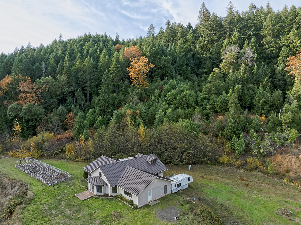 Secluded end-of-the-road mountain retreat on nearly 100 acres of natural beauty with stunning mountain and valley views. This 3BD/2BA, 3100+ sq. ft. energy-efficient home (built in 1992) features a bright, open floor plan with all main-level living plus a study/library. Enjoy a recently remodeled bathroom, custom built-in gun cabinets, and beautiful custom burl wood countertops. Attached cold room is ideal for growing or meat processing, complete with drainage and stainless steel sink. Includes a private 1180 sq. ft. guest house, year-round pond, and marketable timber. Bordered by BLM on two sides with trails throughout for hiking and riding — the perfect private getaway!