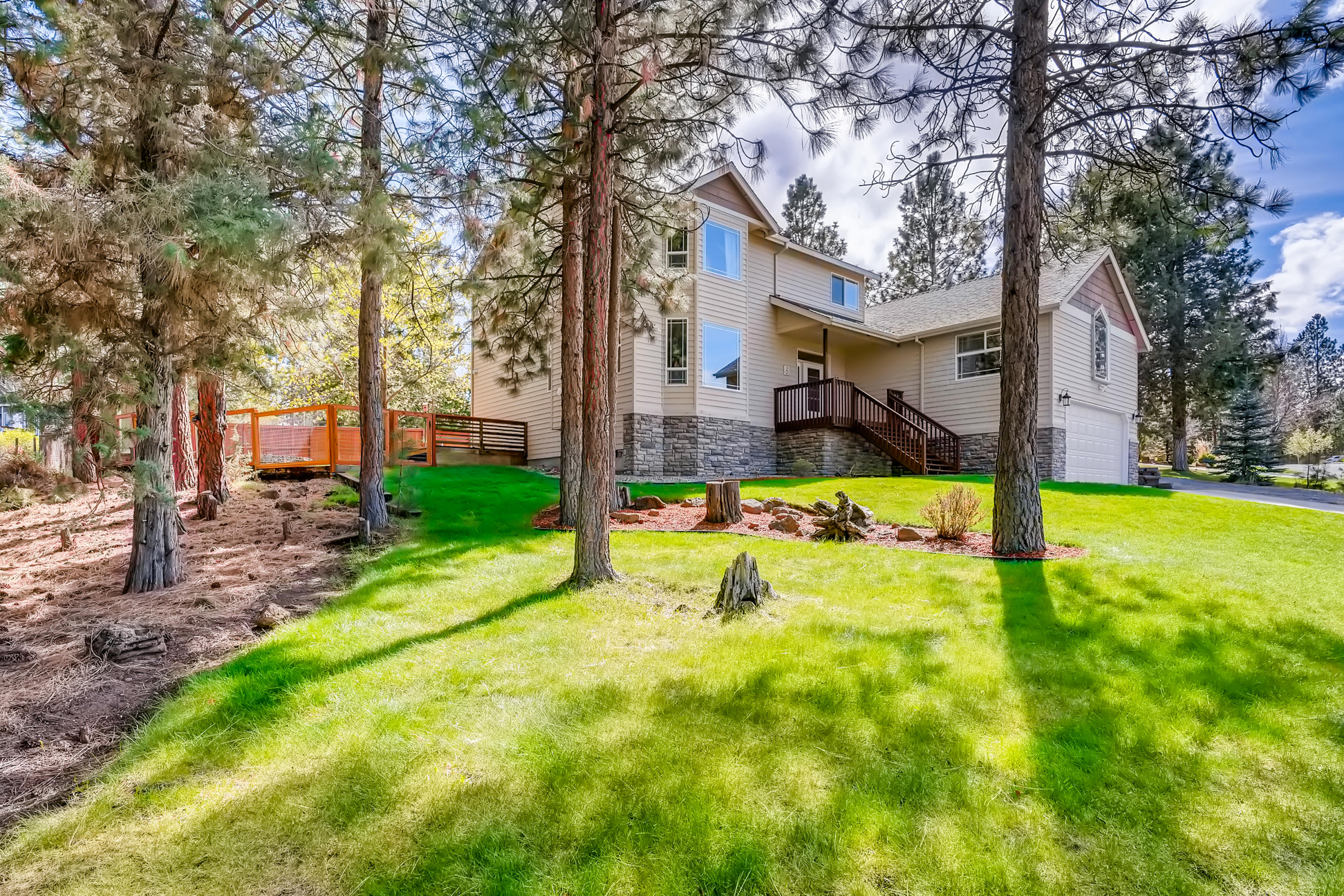 A Rare Find! This 1/2 acre homesite provides a private, park-like setting. It's a short distance to the Deschutes River Trail system and a 5 minute drive to the Old Mill District. The completely remodeled gourmet kitchen features Quartz countertops, new cabinets with pull outs and new stainless steel appliances. Hardwood flooring was recently installed throughout the main living areas. The main bathroom has been thoroughly  updated as well. The traditional floorplan includes three large bedrooms upstairs, each with a vaulted ceiling and views of Awbrey Butte from the Master. The spacious and versatile bonus room/4th bedroom incorporates a separate entryway and its own 1/2 bath, A large deck extends the length of this home and provides a great space for relaxing or entertaining with an arbor providing summertime shade. Property includes a 3 car tandem garage and a huge 21'X41' concrete pad with plenty of room for your RV, boat or  perhaps an additional place to play.