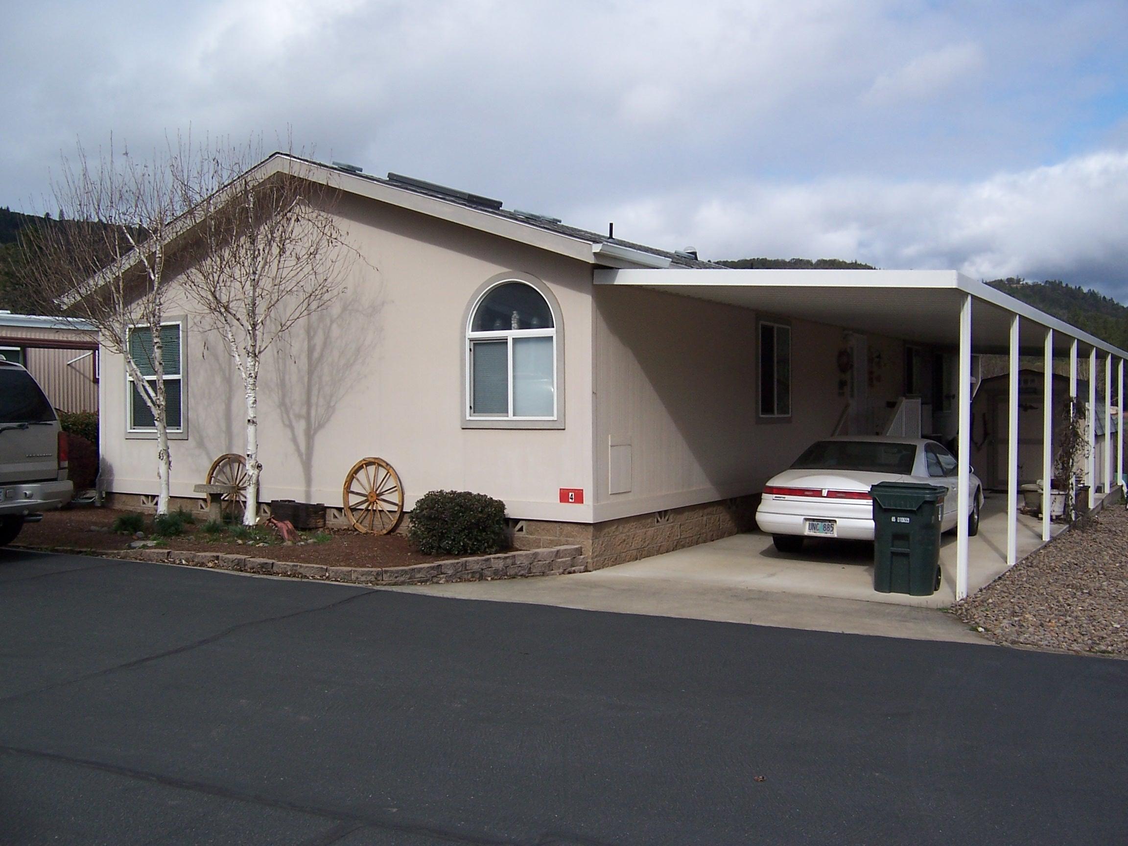 Much desired Madrone Hill MH park. Check out this beautiful & quiet 55+ park located approx. 1 mile to the Laurel Hill Golf Course, close to the Rogue River & only a short distance to I-5 access. This quality home is situated in one of the best locations in the park, with a huge covered rear deck overlooking open space/fields with gorgeous views, private & great for entertaining. This 2006 built 3 bedroom/2.0 bath home includes: vaulted ceilings, sky-lites/solar tubes, tall windows with tons of natural light, Large open kitchen with hardwood cabinets, breakfast bar & walk-in pantry. The vaulted dining & living room have easy access to the rear deck. Nice size utility room with room for an extra frig. Guest bedroom #1/den located off the front entry with French doors. Large vaulted Master bedroom with closet, Master Bath with double walk-in closets, Dbl-sink vanity, jetted tub & separate 4' stall shower. This home has Hardi-Plank siding, carport, Stg-shed & covd front entry porch.