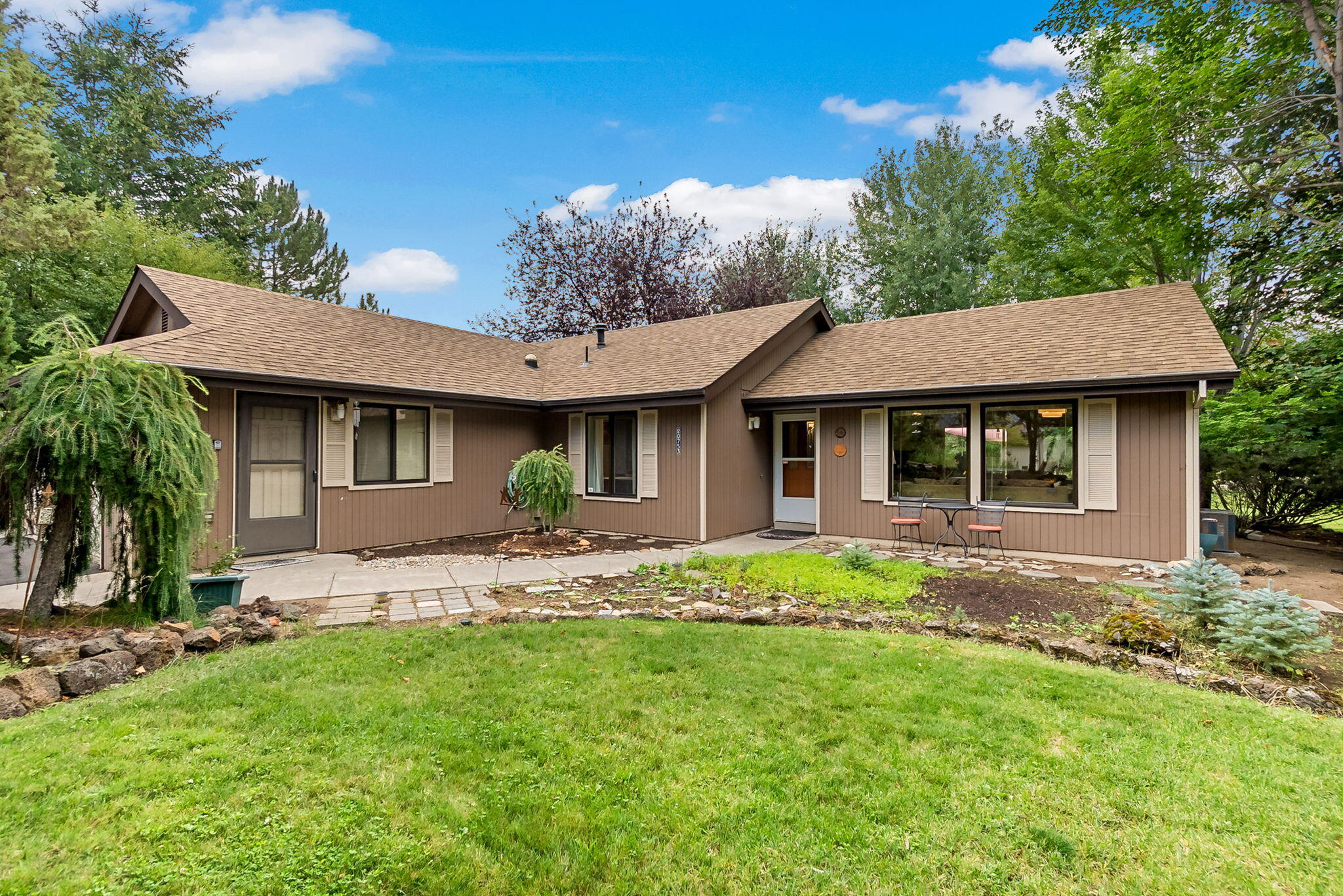 With serene canal views and easy access to the central Oregon canal trail system this home offers an unbeatable location.   Inside this single-level retreat, you'll find an open floor plan with vaulted ceilings, fresh flooring, updated light fixtures throughout, and stainless steel appliances. The primary suite features a beautifully remodeled primary bath with a skylight in the full tile shower including a  glass door. The custom vanity features soft close extra deep drawers, under cabinet lighting and a quartz countertop.   Storage is abundant with garage shelving, attic storage, and a finished storage room for all your gear plus a garden shed!  Step outside onto a  large new (2024) easy care composite deck, an ideal spot to take in the wildlife and peaceful waterfront canal setting. Prefer low-maintenance living? The HOA provides lawn care, irrigation, snow removal and yard waste pick up, leaving you more time to enjoy your surroundings. Centrally located & close to Alpenglow Park!