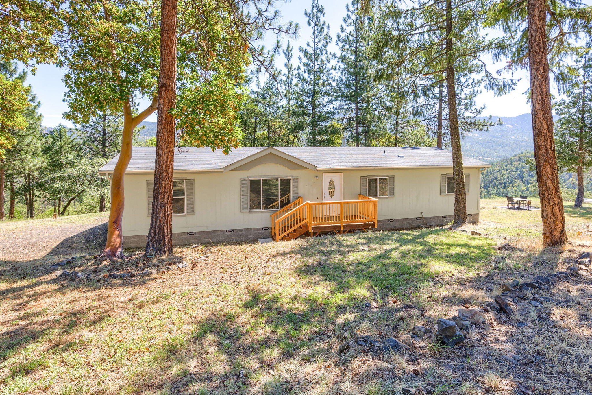 Enjoy peace, privacy, and panoramic views from this 2007 manufactured home nestled on 10 serene acres. This 3-bedroom, 2-bathroom property offers an open, airy feel with vaulted ceilings and abundant natural light. The primary suite includes a spacious walk-in closet and a bathroom with a walk-in shower and new toilet. Recent upgrades include a newer HVAC system and additional new toilets throughout. Step outside to find rebuilt front and back decks perfect for relaxing or entertaining, plus ideal garden space for your green thumb. Well tested 4.15gmp for a 4 hr recent flow test and there is an engineer certification. This is country living at its best—schedule your private showing today!