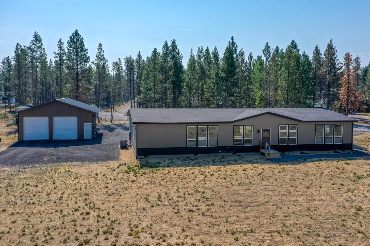 Experience the perfect Central Oregon lifestyle in this beautiful country home on 1.5 acres with stunning mountain views. The open-concept living area features beautiful wood laminate floors and is flooded with natural light. The spacious kitchen is a chef's dream, with a large island, extensive counter space, and a huge pantry. The dining area has a patio slider for easy indoor-outdoor living. The primary suite offers a well-designed en suite and a walk-in closet, while a versatile bonus room is ideal for a home office, game room, gym, or ???. The spacious 30x30 garage/shop has 200-amp service and a 50-amp RV hookup, providing space for all your toys. NEW CHIP SEAL ON DRIVE..With a solid 20 GPM well and city services recently expanded to the area, this property is built to last. Enjoy a prime location just minutes from town, shopping, and all the fishing, skiing, and water sports Central Oregon is famous for. The school bus even stops at the corner. Don't miss this must-see property!
